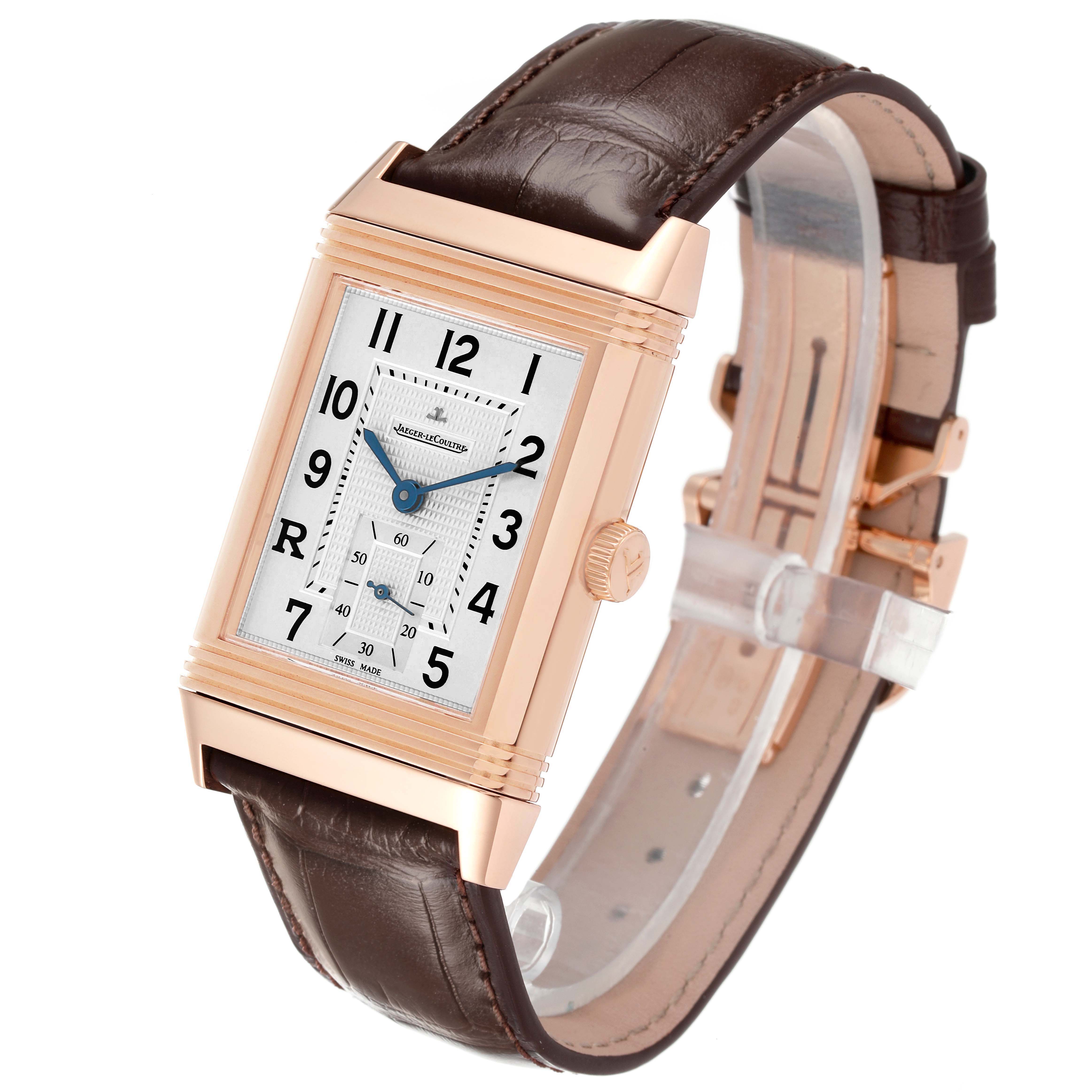 The Reverso model by Jaeger LeCoultre is shown at an angle highlighting the case, crown, dial, and strap.
