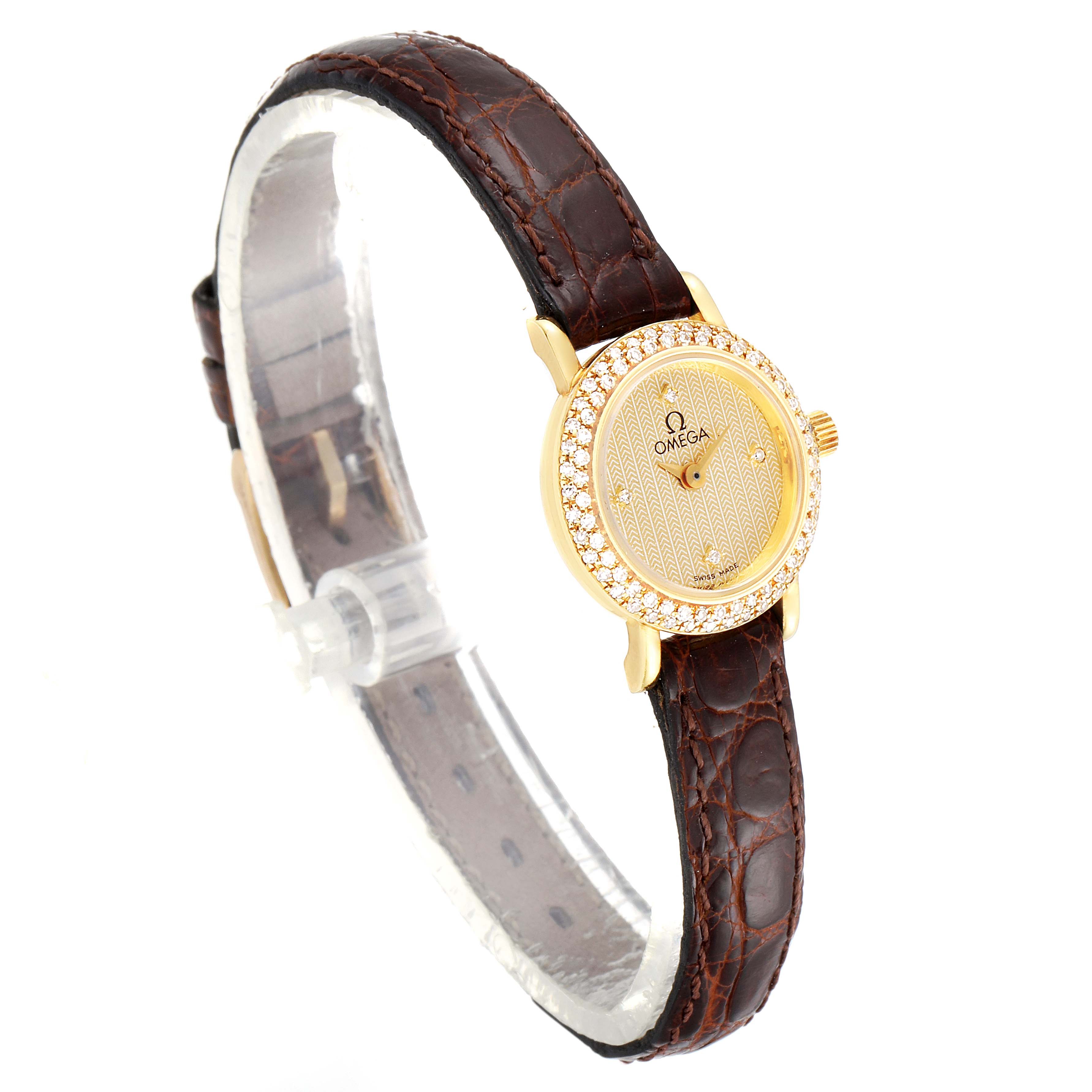 The image shows an angled view of the Omega 1450 Women's Yellow Gold Champagne Dial 1450 Women's Yellow Gold Champagne Dial DeVille Mini Yellow Gold Diamond Cocktail Ladies Watch 1450, focusing on the face and strap.