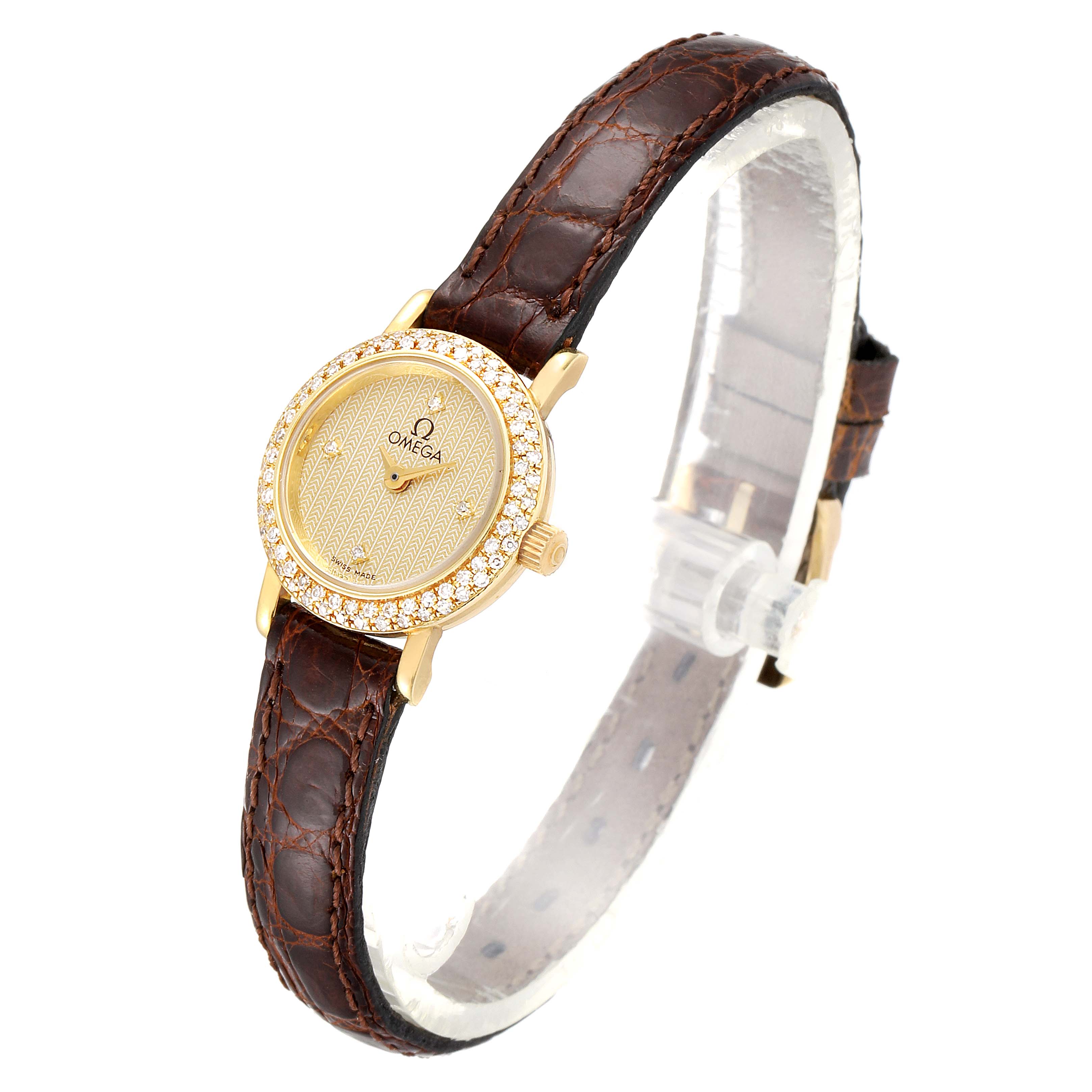 The DeVille Mini Yellow Gold Diamond Cocktail Ladies Watch by Omega 1450 Women's Yellow Gold Champagne Dial 1450 Women's Yellow Gold Champagne Dial is shown from a side angle, highlighting the watch face, bezel, and strap.