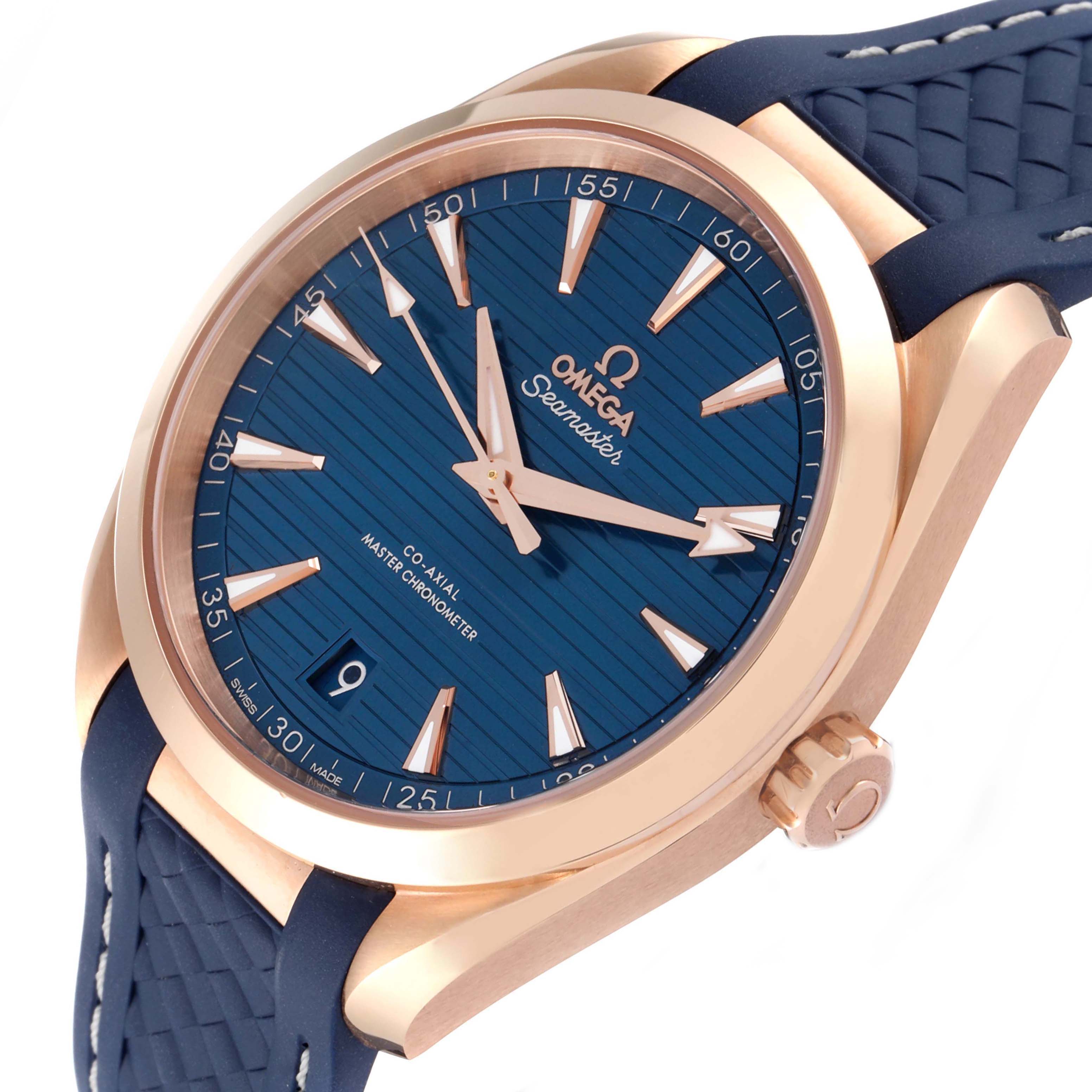 The image shows an angled close-up of the Omega Aqua Terra 220.52.41.21.03.001 Men's Rose Gold Blue Dial watch, highlighting the blue dial, rose gold case, and textured strap.