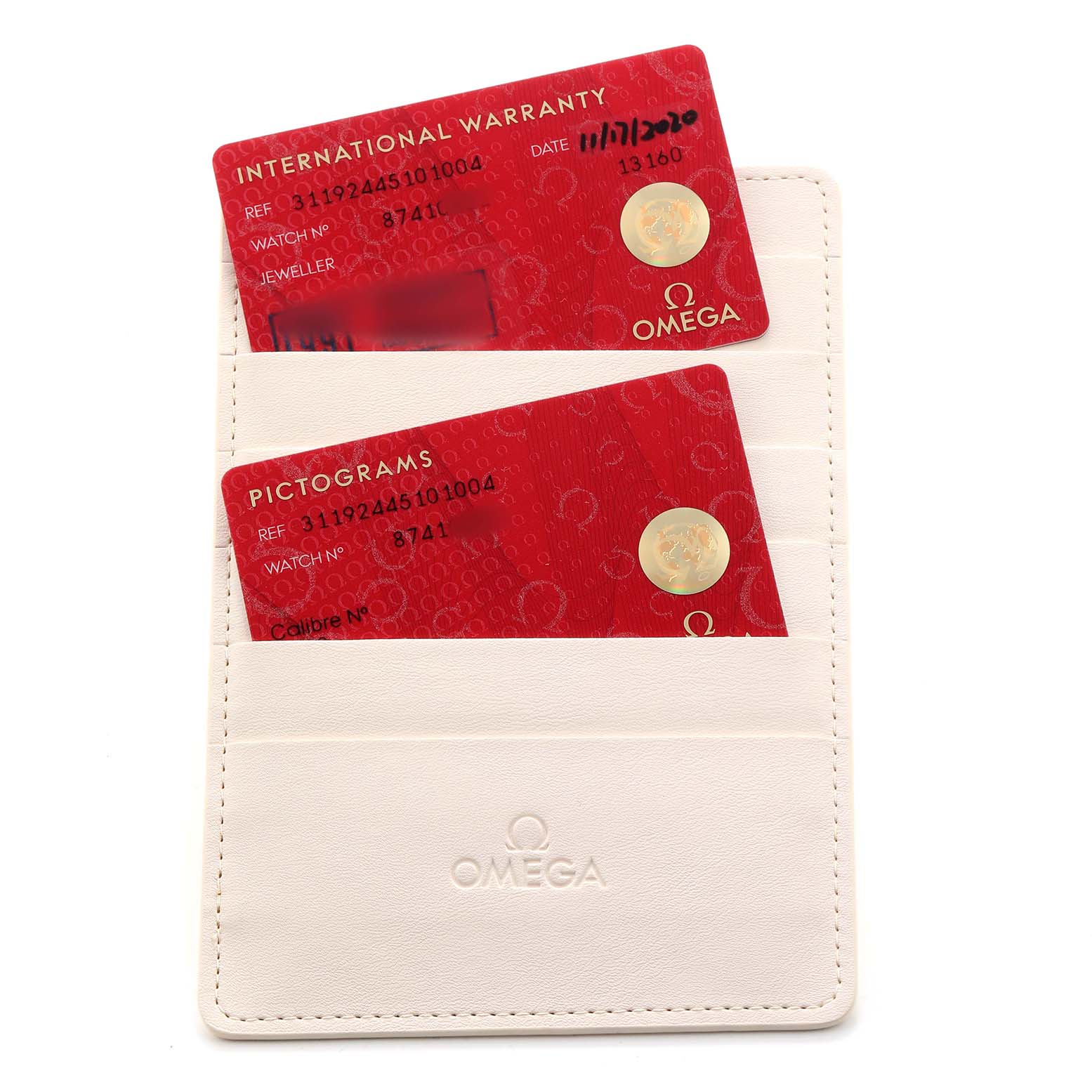 The image shows Omega Speedmaster O311.92.44.51.01.003 Men's Ceramic Black Dial's warranty and pictogram cards in a cream Omega cardholder.