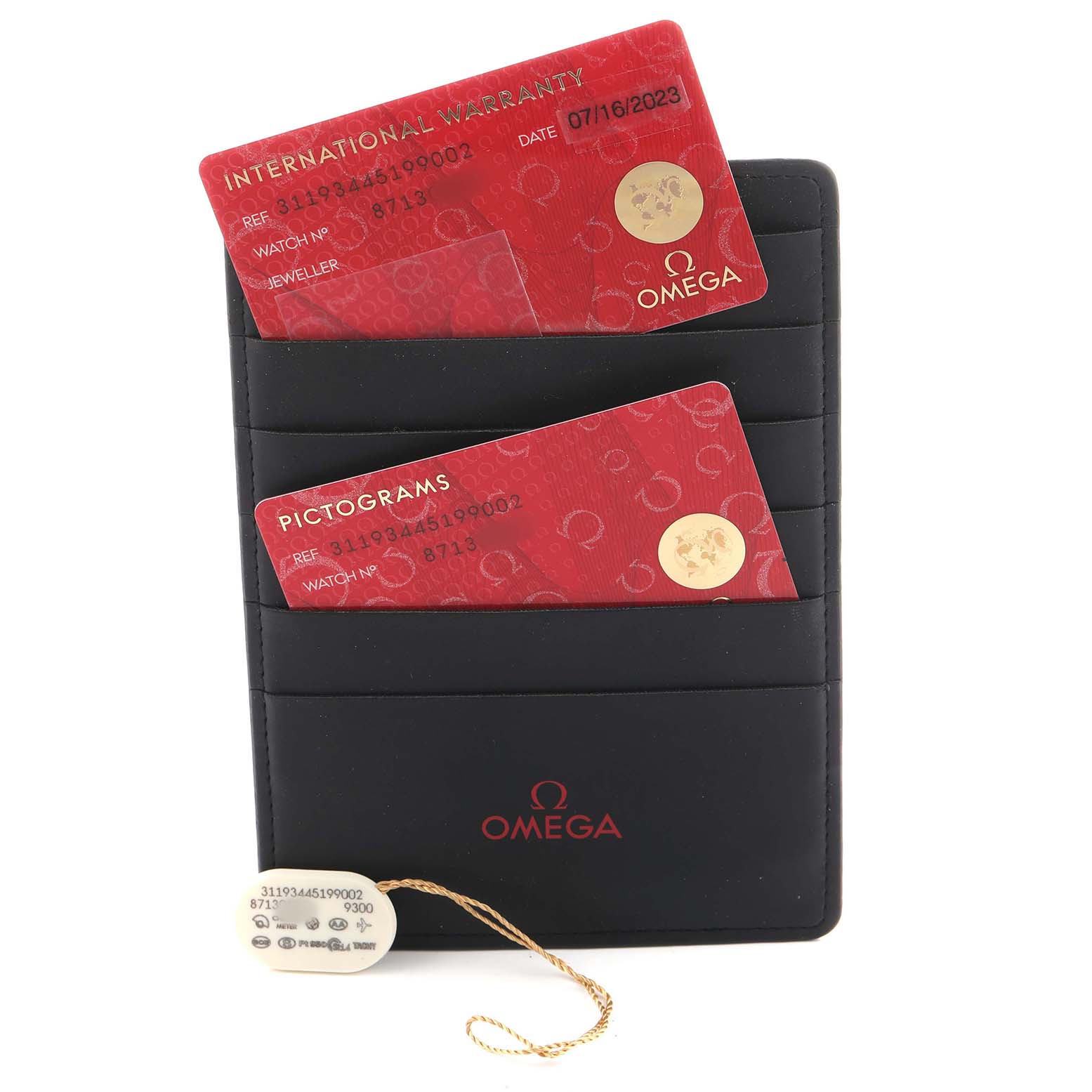 The image shows Omega Speedmaster 311.93.44.51.99.002 Men's Ceramic Silver Dial watch accessories, including warranty cards in a cardholder and a hang tag.