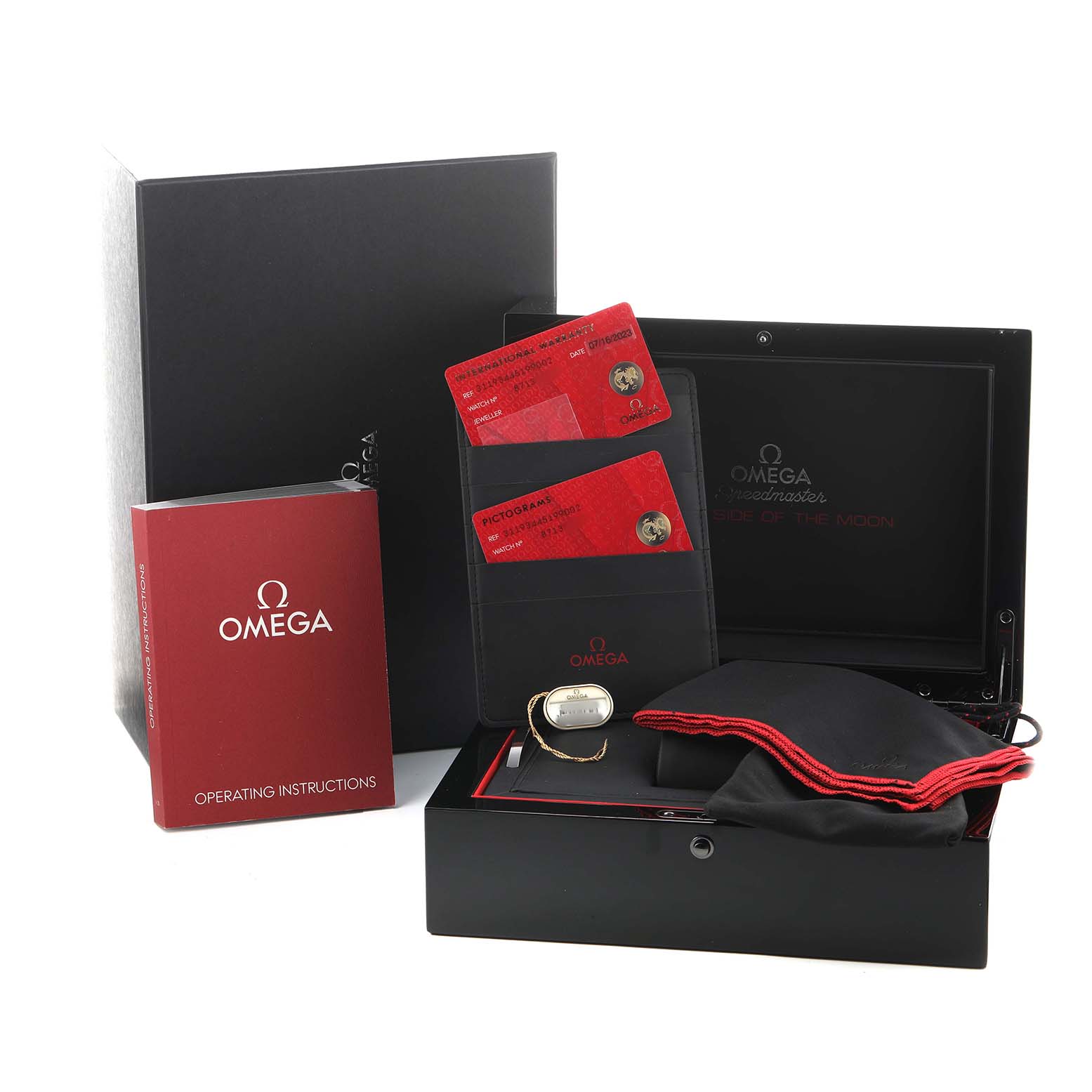 The image shows Omega Speedmaster 311.93.44.51.99.002 Men's Ceramic Silver Dial packaging with a box, instruction manual, cards, and a protective pouch.