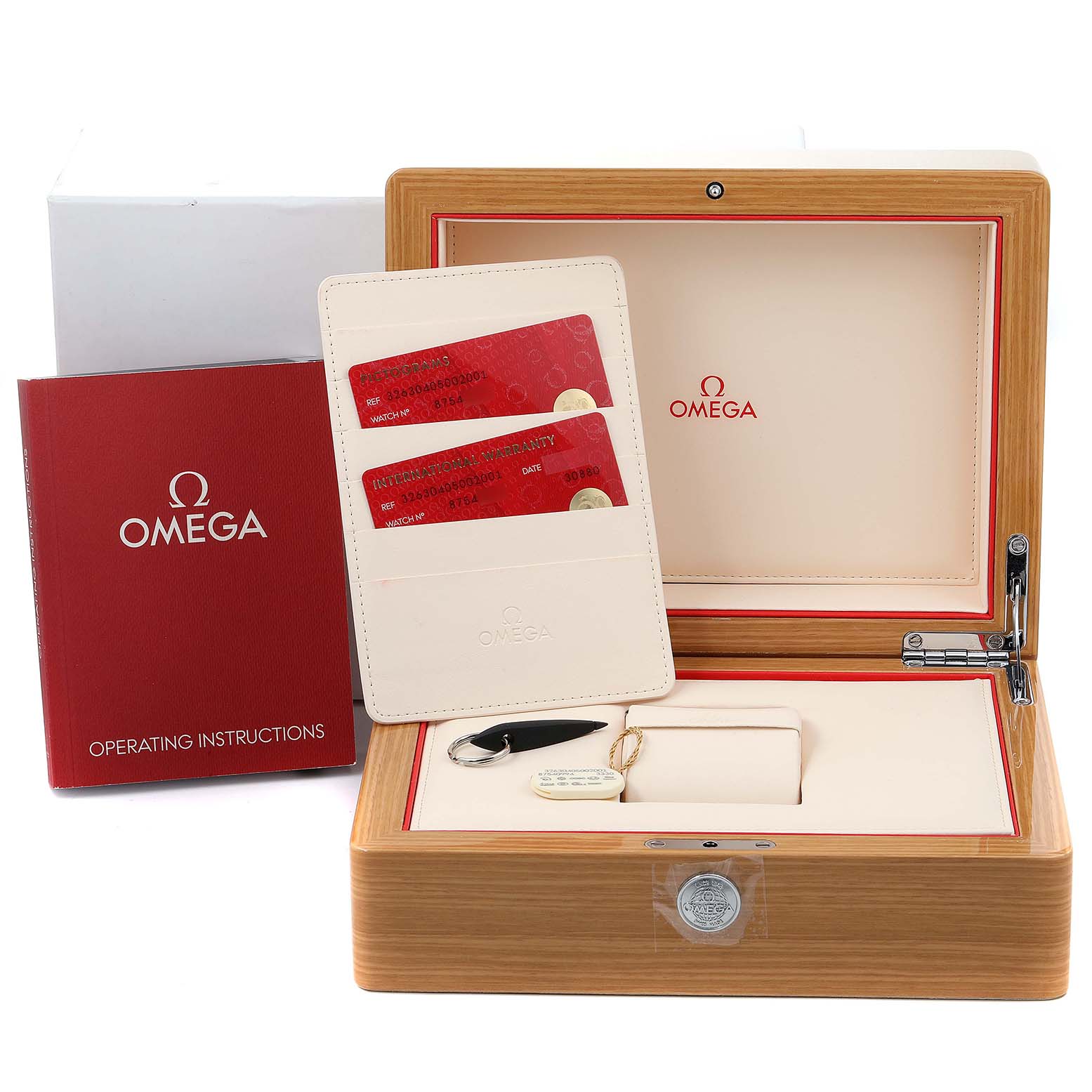 The image shows an Omega Speedmaster 326.30.40.50.02.001  Men
s Stainless Steel Silver Dial 326.30.40.50.02.001  Men
s Stainless Steel Silver Dial watch box, operating instructions, warranty cards, and a keychain.