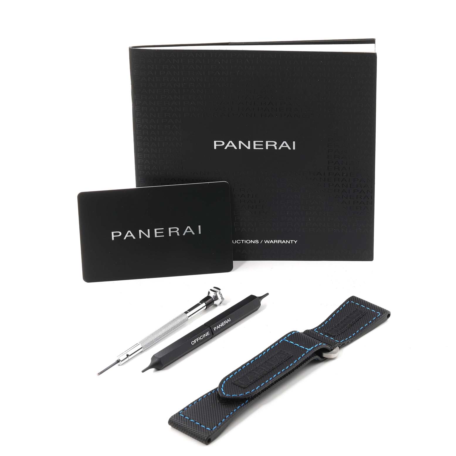 This image shows accessories for the Panerai Submersible PAM00982 Men's Titanium Grey Dial PAM00982 Men's Titanium Grey Dial model, including tools, a strap, a warranty card, and documentation.