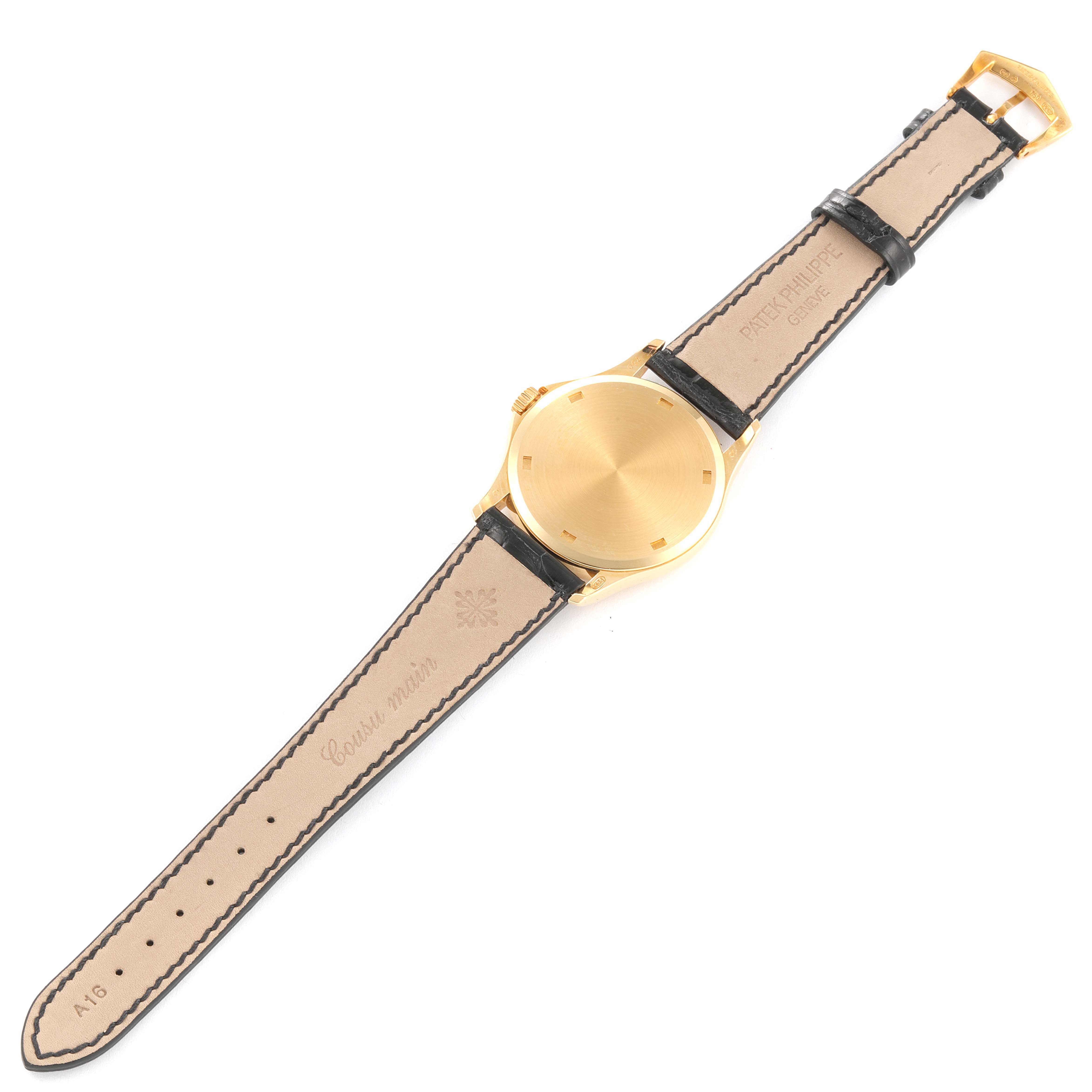 The image shows a Patek Philippe Calatrava 5115J Men's Yellow Gold White Dial 5115J Men's Yellow Gold White Dial model watch from the back, displaying the strap, buckle, and caseback.