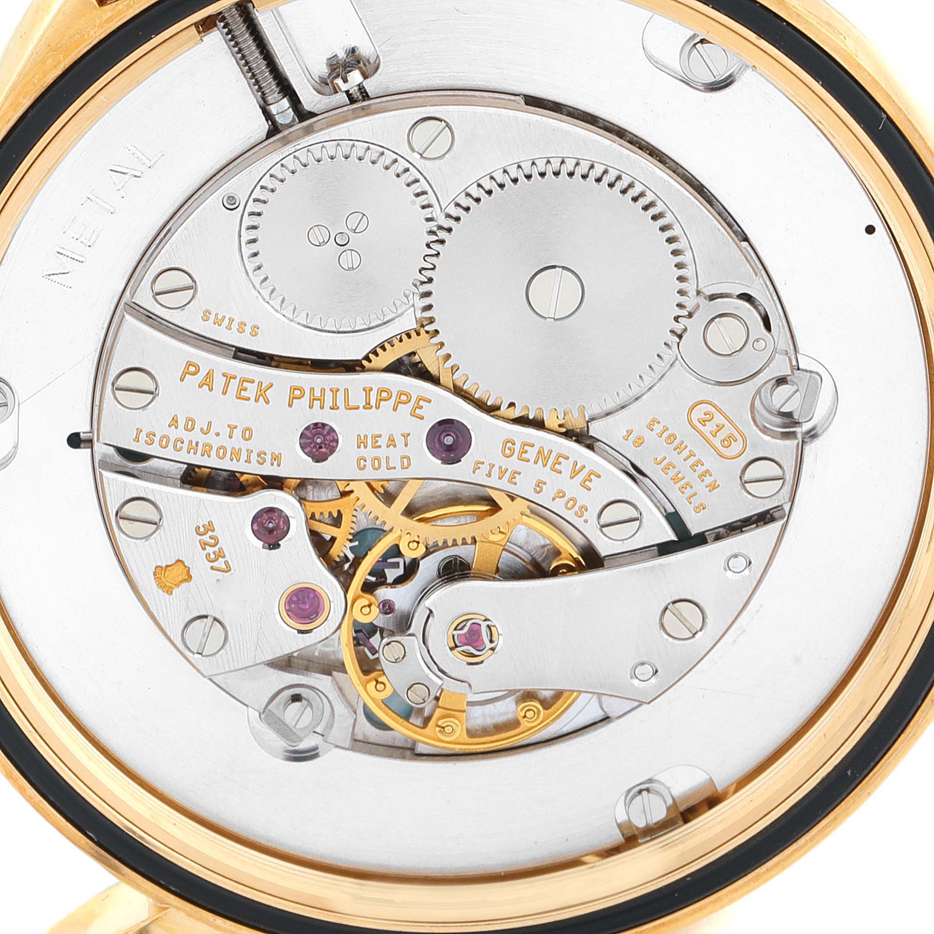 The image shows the back view of a Patek Philippe Calatrava 5115J Men's Yellow Gold White Dial 5115J Men's Yellow Gold White Dial watch, featuring its intricate mechanical movement components.