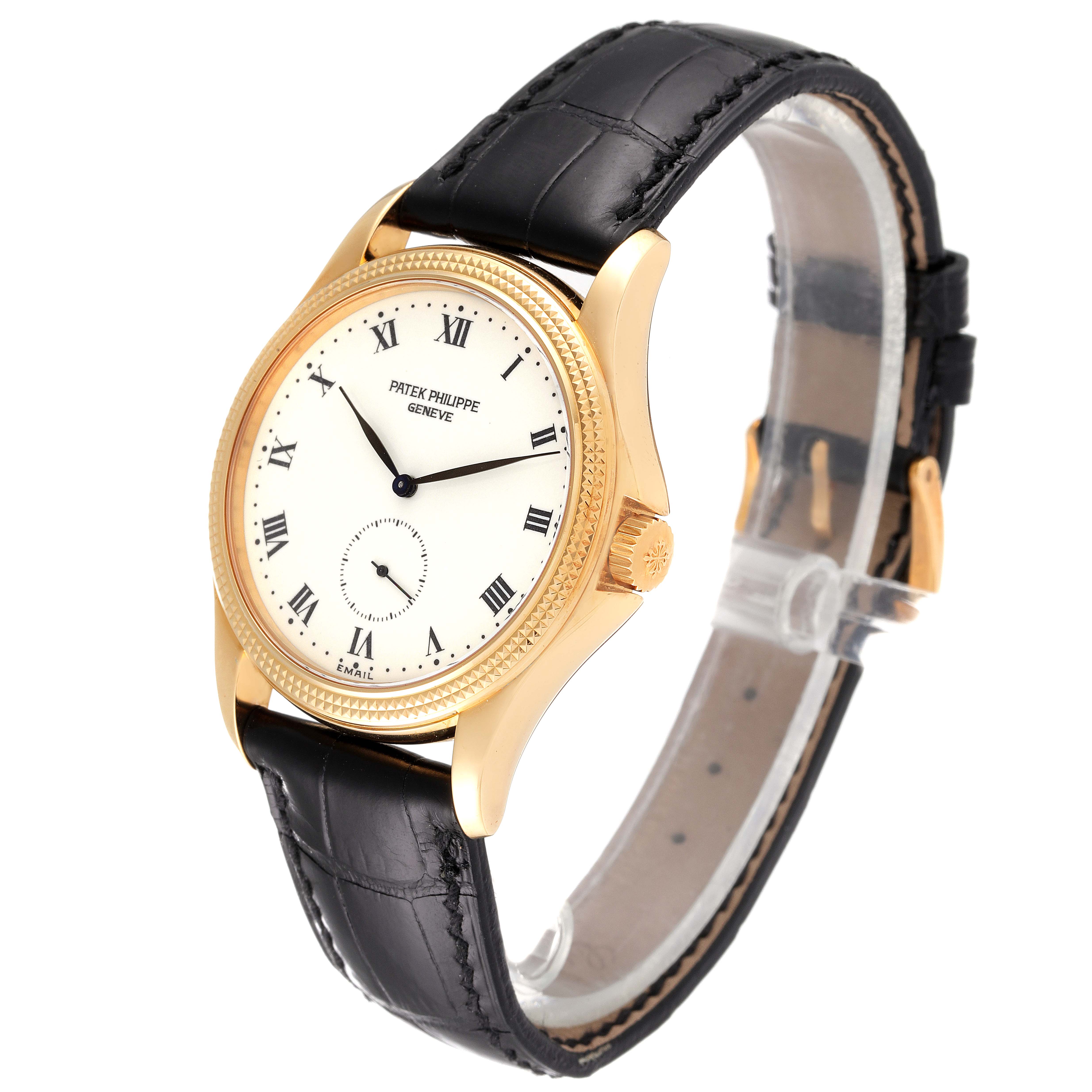 The image shows a Patek Philippe Calatrava 5115J Men's Yellow Gold White Dial 5115J Men's Yellow Gold White Dial watch at a three-quarter angle, highlighting its gold case, black leather strap, and white dial with Roman numerals.