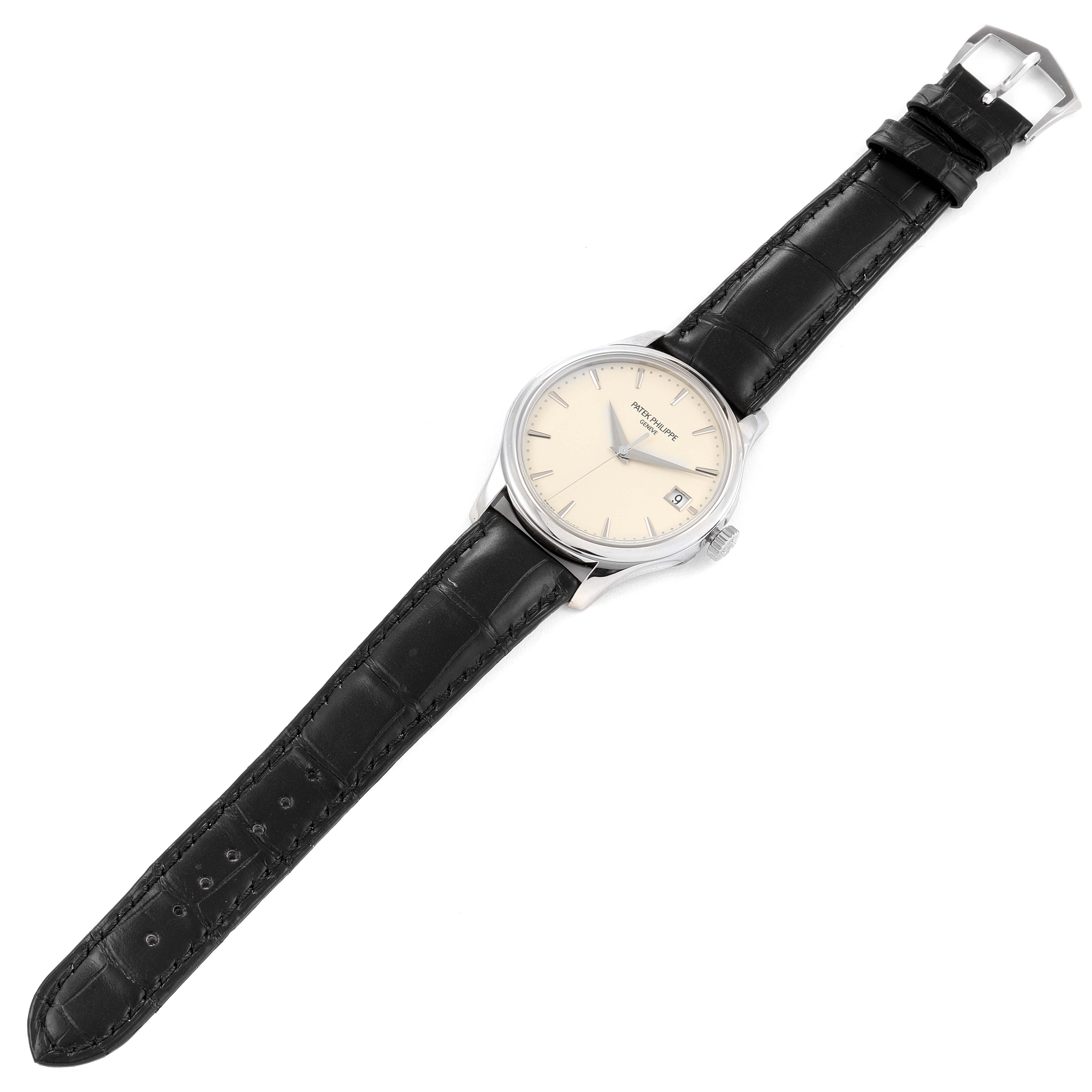 The image shows a Patek Philippe Calatrava 5227G Men's White Gold Silver Dial 5227G Men's White Gold Silver Dial watch from a top-down angle, featuring its face, black leather strap, and buckle.