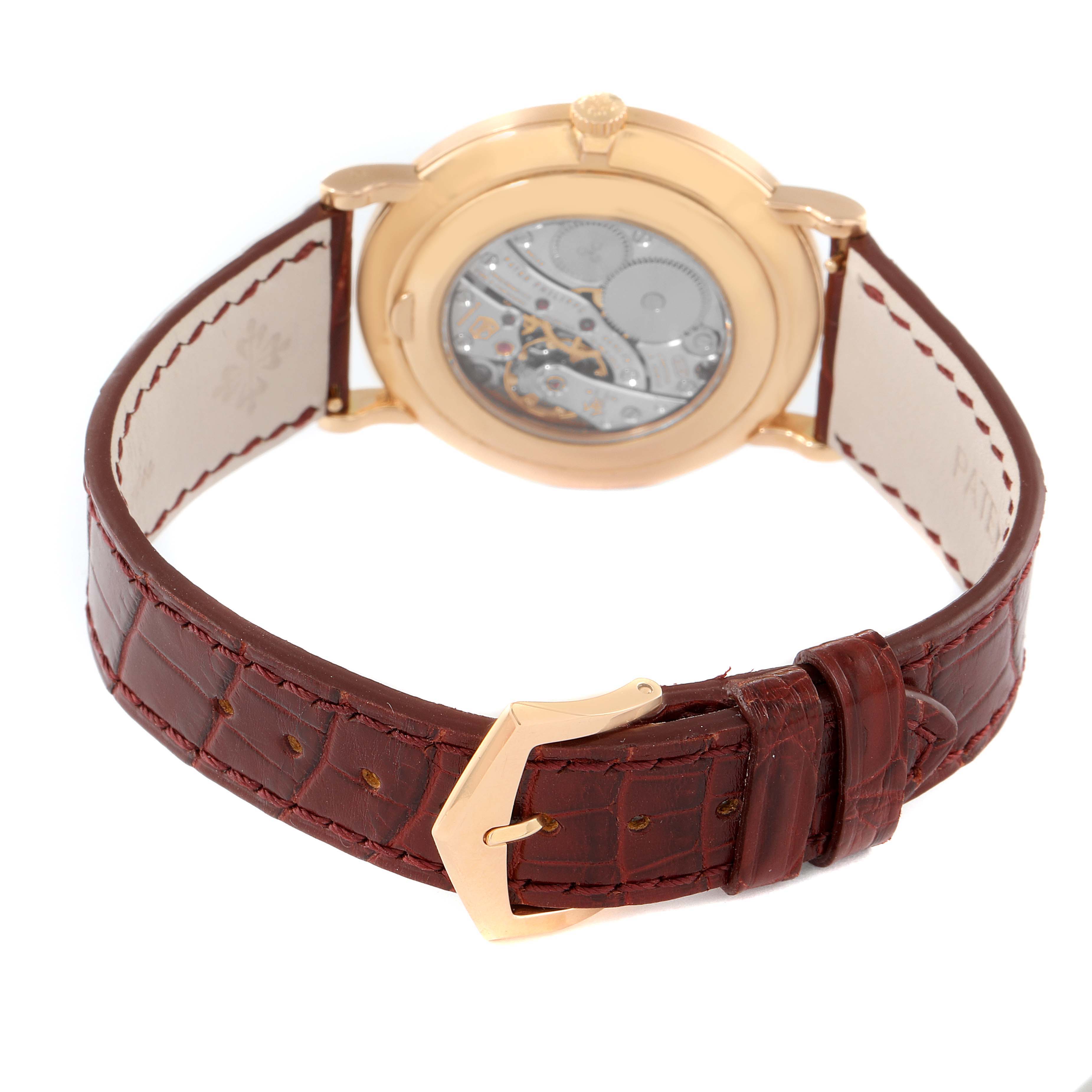 This image shows the back and leather strap of a Patek Philippe Calatrava 5119R Men's Rose Gold White Dial 5119R Men's Rose Gold White Dial model watch at a slight angle.