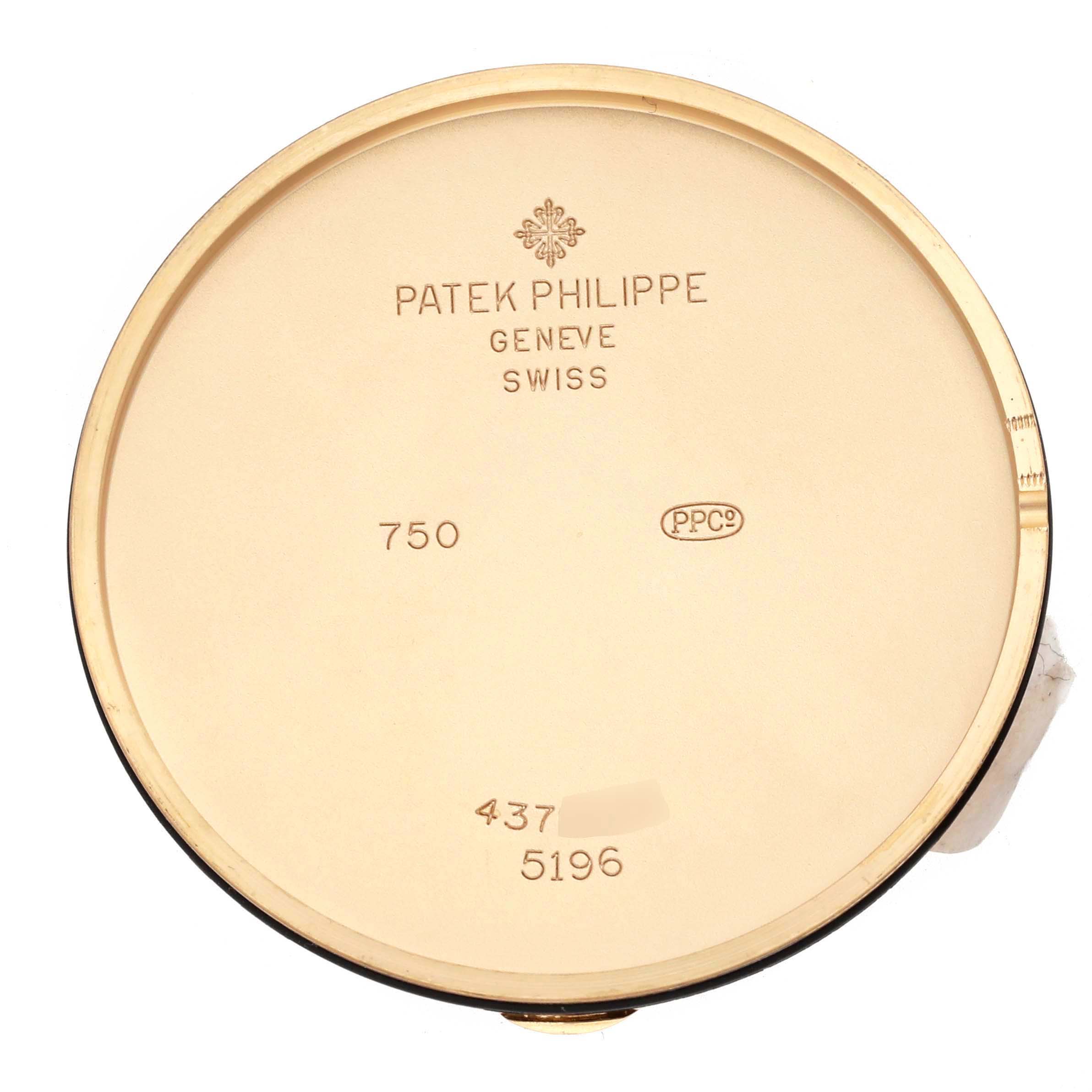 The image shows the back cover of a Patek Philippe Calatrava 5196J Men's Yellow Gold Silver Dial watch, focusing on its engravings and details.