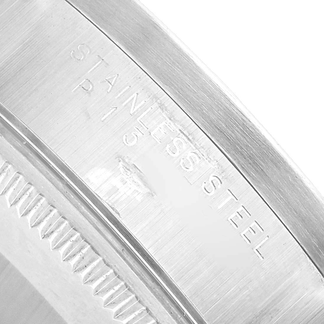 The image shows a close-up of the stainless steel case edge of the Rolex Air-King 14010 Men's Stainless Steel White Dial, highlighting the engraved text.