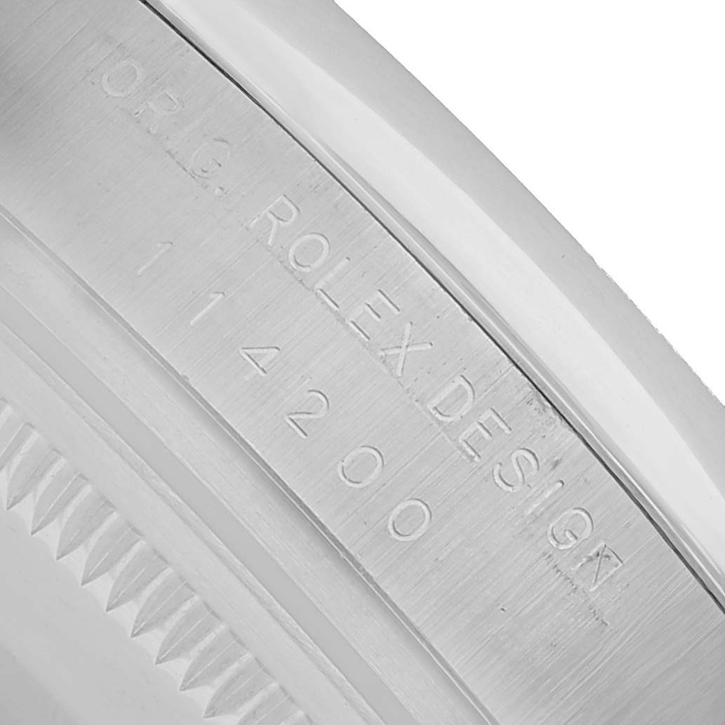 The image shows a close-up of the engraved inner bezel of a Rolex Air-King 114200 Men's Stainless Steel Silver Dial watch, displaying the model number and design details.