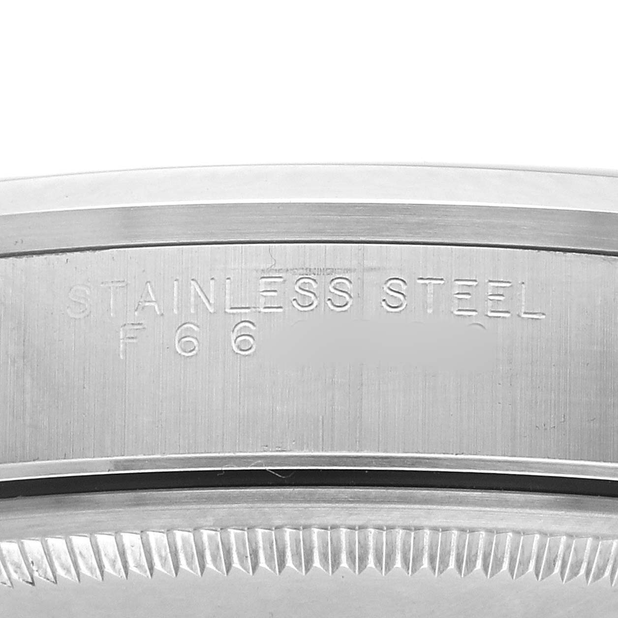 The image shows a close-up side view of the bezel and the "STAINLESS STEEL" engraving on the Rolex Air-King 14000 Men's Stainless Steel Silver Dial watch case.