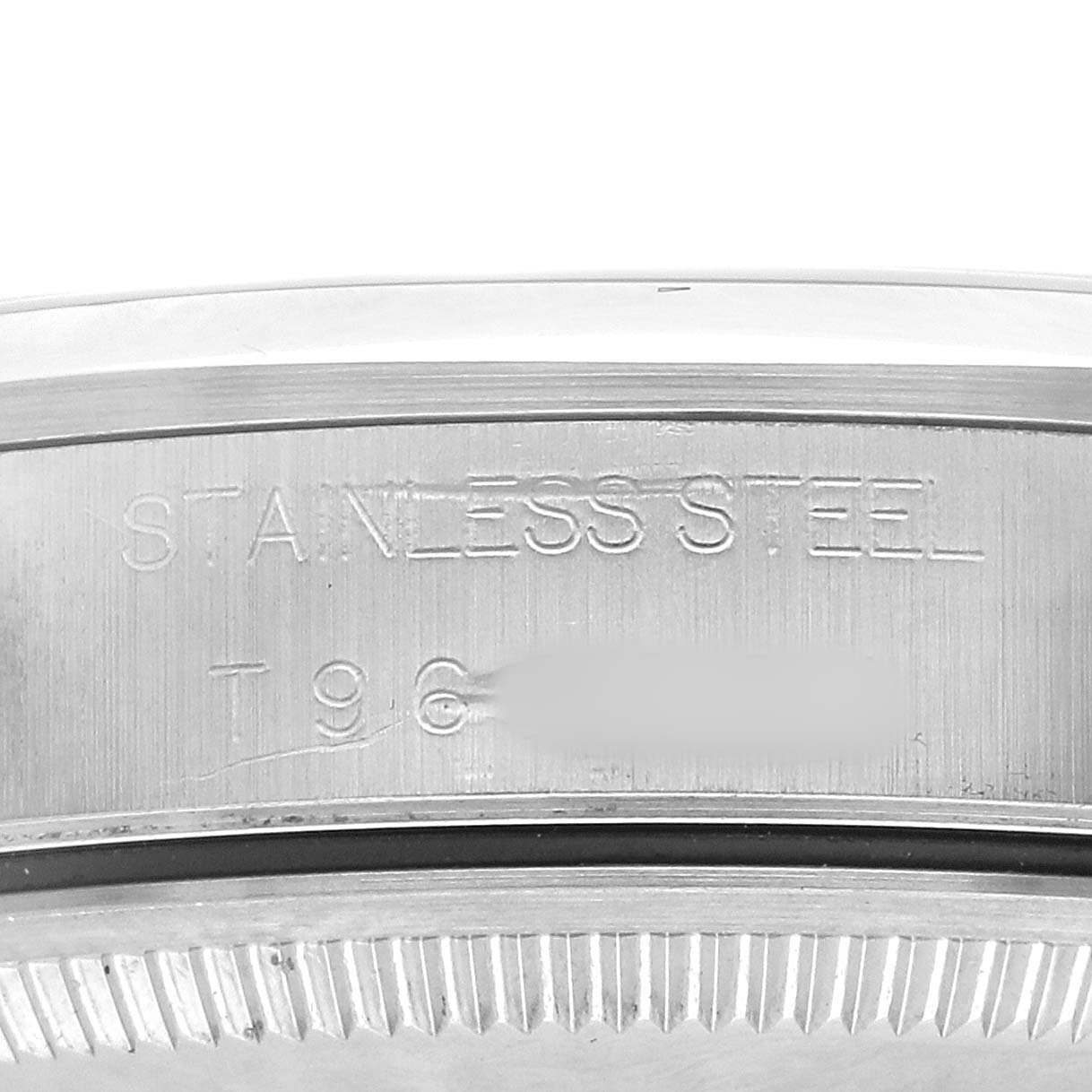 The image shows a close-up of the stainless steel case back edge and engravings on a Rolex Air-King 14000 Men's Stainless Steel Pink Dial watch.