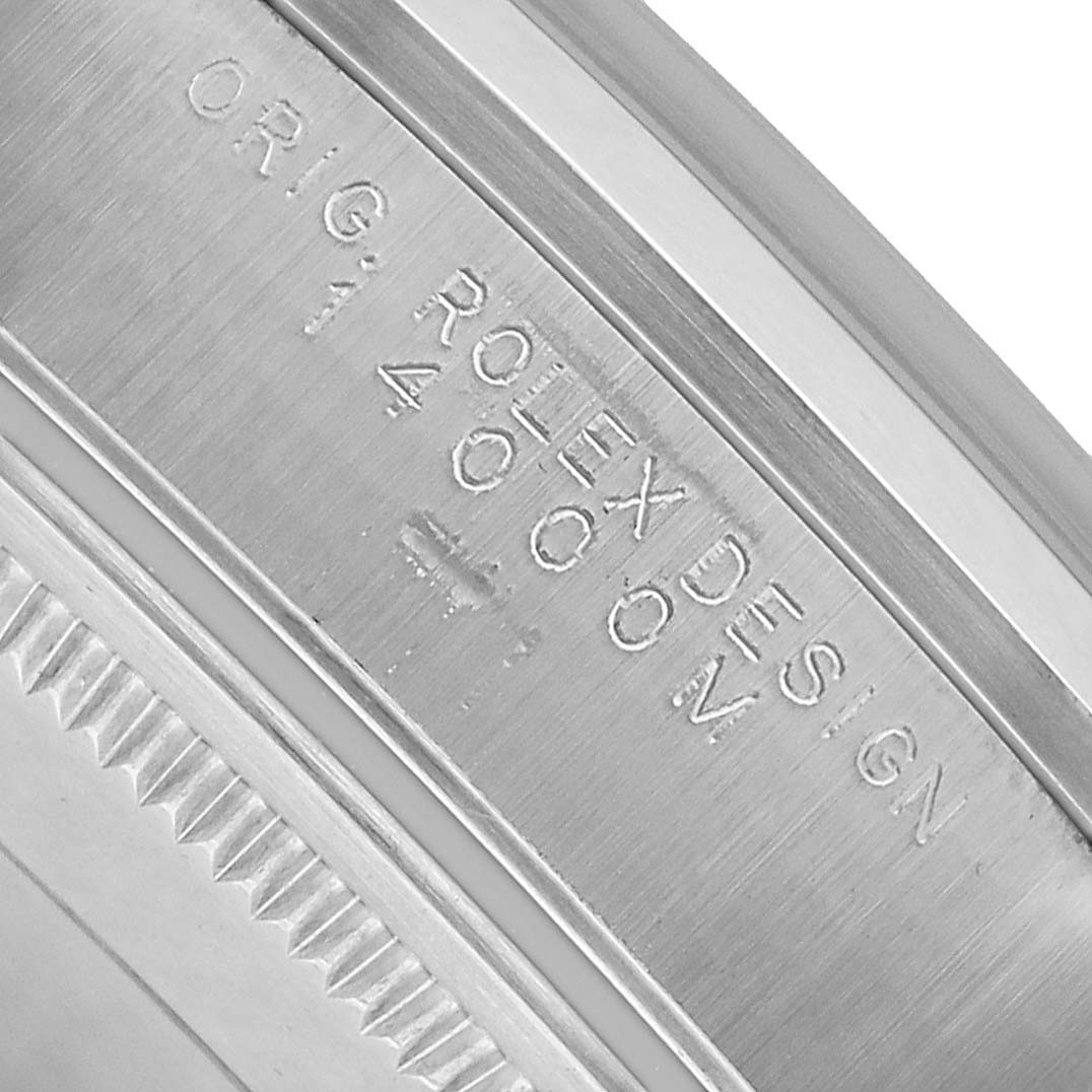 The image shows a close-up of the Rolex Air-King 14000 Men's Stainless Steel Pink Dial watch case, highlighting engraved details and a portion of the bezel.