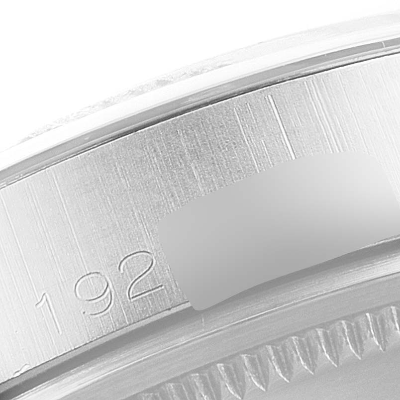 This image shows a close-up of the side of a Rolex Vintage Collection 1500 Men's Stainless Steel Silver Dial 1500 Men's Stainless Steel Silver Dial watch, highlighting its engraved serial number.