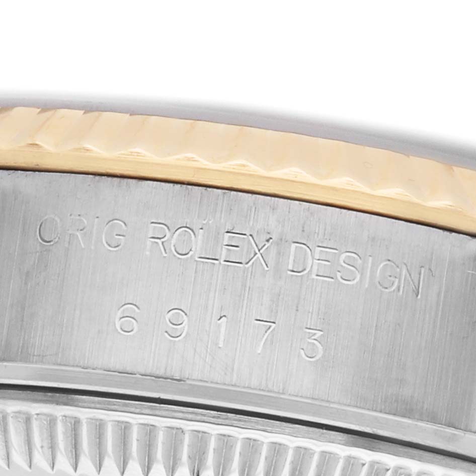 The image shows a close-up of the case side and edge of the bezel of a Rolex Datejust 69173 Women's Steel and Gold (two tone) Red Dial, displaying the model number 69173.