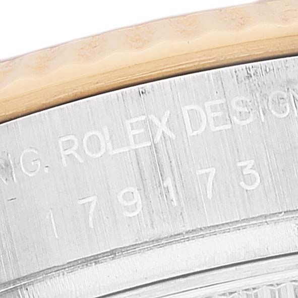 This image shows a close-up of the side of a Rolex Datejust 179173 Women's Steel and Gold (two tone) Silver Dial 179173 Women's Steel and Gold (two tone) Silver Dial watch, featuring the engraved model number and "Rolex Design" text.