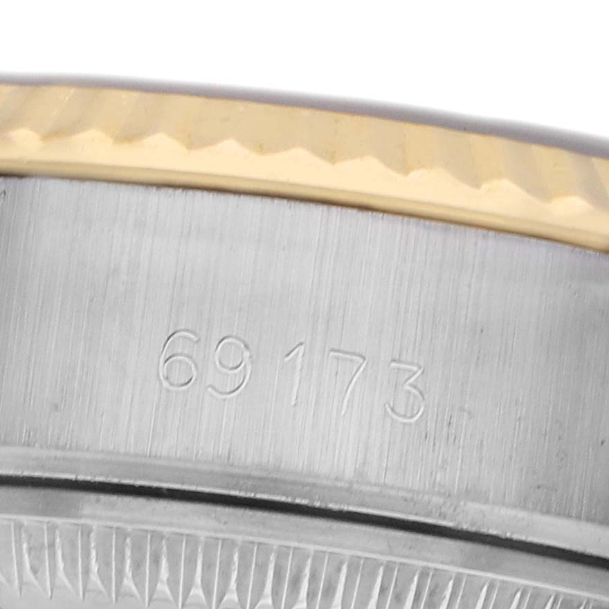 The image shows a close-up of a Rolex Datejust 69173 Women's Steel and Gold (two tone) Champagne Dial model, focusing on the bezel and part of the case, with visible engravings.