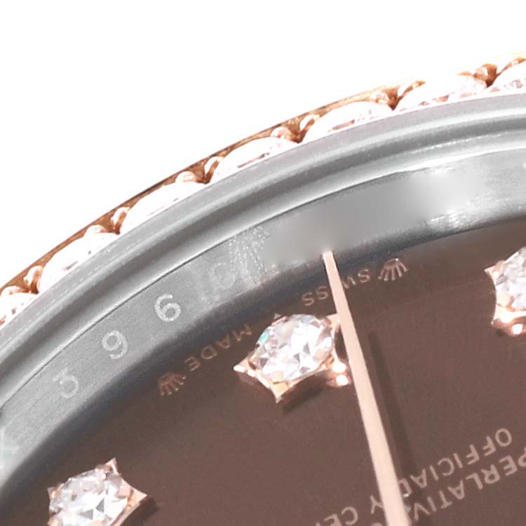 This close-up of the Rolex Datejust 279381 Women's Steel and Gold (two tone) Brown Dial 279381 Women's Steel and Gold (two tone) Brown Dial watch shows the bezel, part of the dial, and diamond markers.