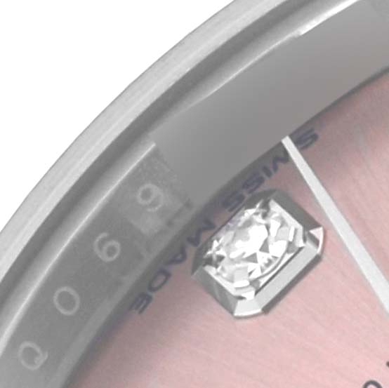 The image shows a close-up of the Rolex Datejust 279174 Women's Stainless Steel Pink Dial 279174 Women's Stainless Steel Pink Dial watch's face, highlighting the date window and a diamond hour marker.