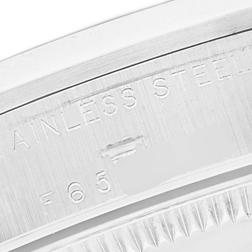 This image shows a close-up of the stainless steel case's inner edge with engravings on a mid-size Rolex watch.