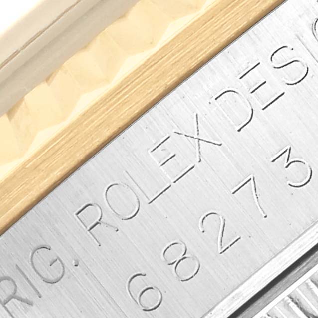 The image shows a close-up of the side of a Rolex Mid-Size 68273 Women's Steel and Gold (two tone) Champagne Dial 68273 Women's Steel and Gold (two tone) Champagne Dial model, featuring the engraved design number and part of the bezel.