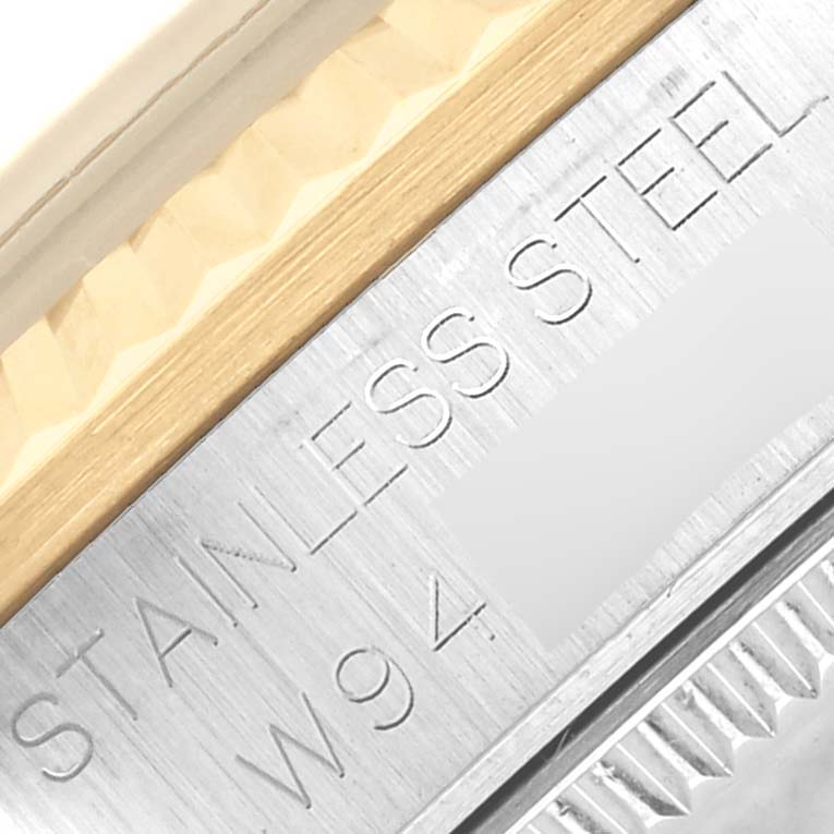 The image shows a close-up angle of the edge of a Rolex Mid-Size 68273 Women's Steel and Gold (two tone) Champagne Dial 68273 Women's Steel and Gold (two tone) Champagne Dial watch, highlighting the stainless steel engraving on the bezel.