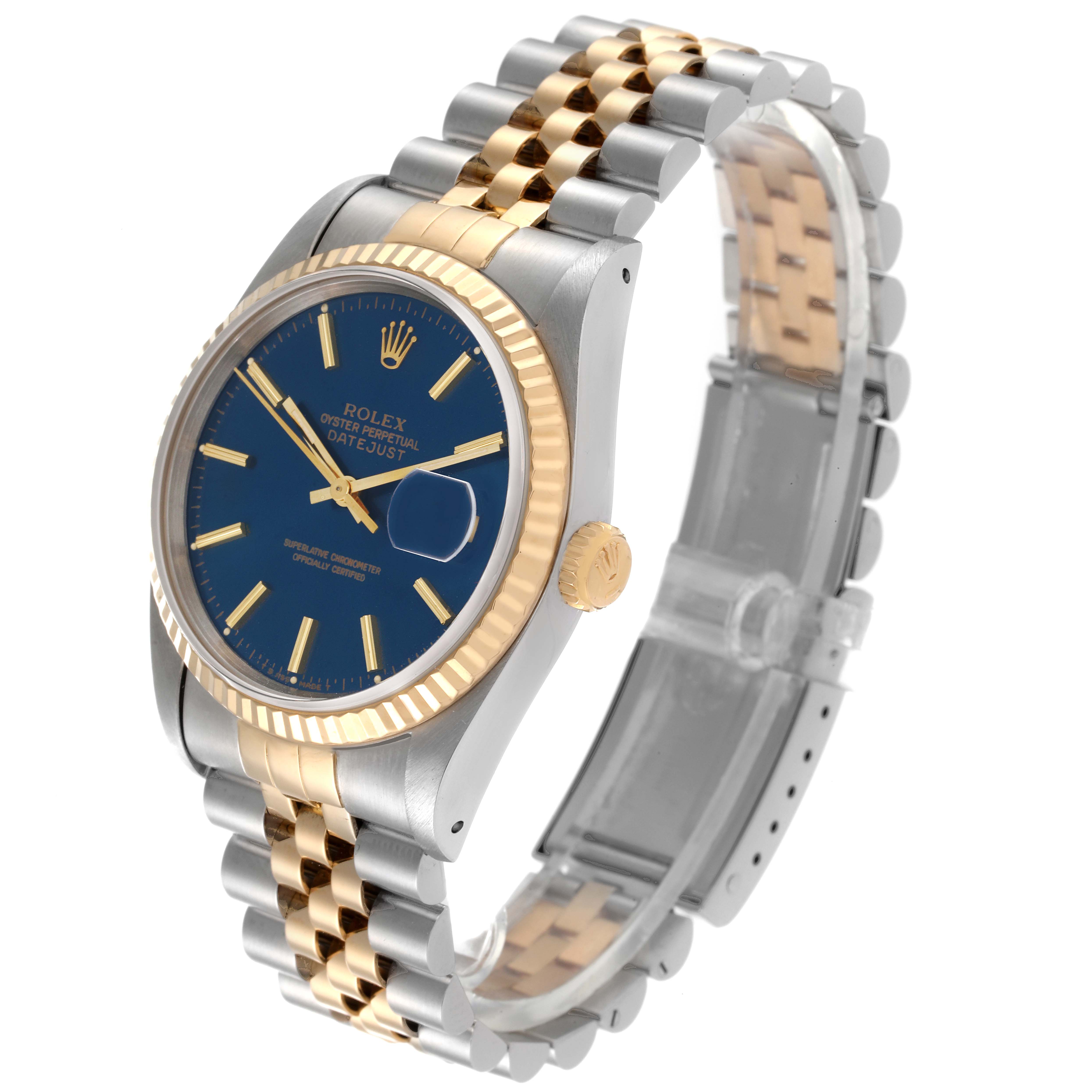 The Rolex Datejust 16233 Men's Steel and Gold (two tone) Blue Dial 16233 Men's Steel and Gold (two tone) Blue Dial watch is shown at an oblique angle, highlighting its blue dial, bi-color Jubilee bracelet, and fluted bezel.