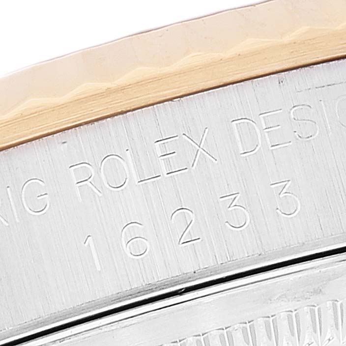 Close-up of the bezel and case side of a Rolex Datejust 16233 Men's Steel and Gold (two tone) Blue Dial 16233 Men's Steel and Gold (two tone) Blue Dial, showing the model number and "ORIG ROLEX DESIGN" engraving.