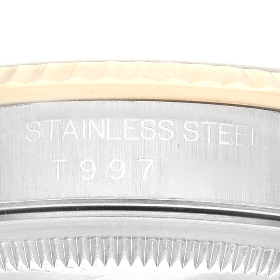 The image shows a close-up of the side of a Rolex Datejust 16233 Men's Steel and Gold (two tone) Black Dial 16233 Men's Steel and Gold (two tone) Black Dial watch case, displaying "STAINLESS STEEL" and partial serial number.
