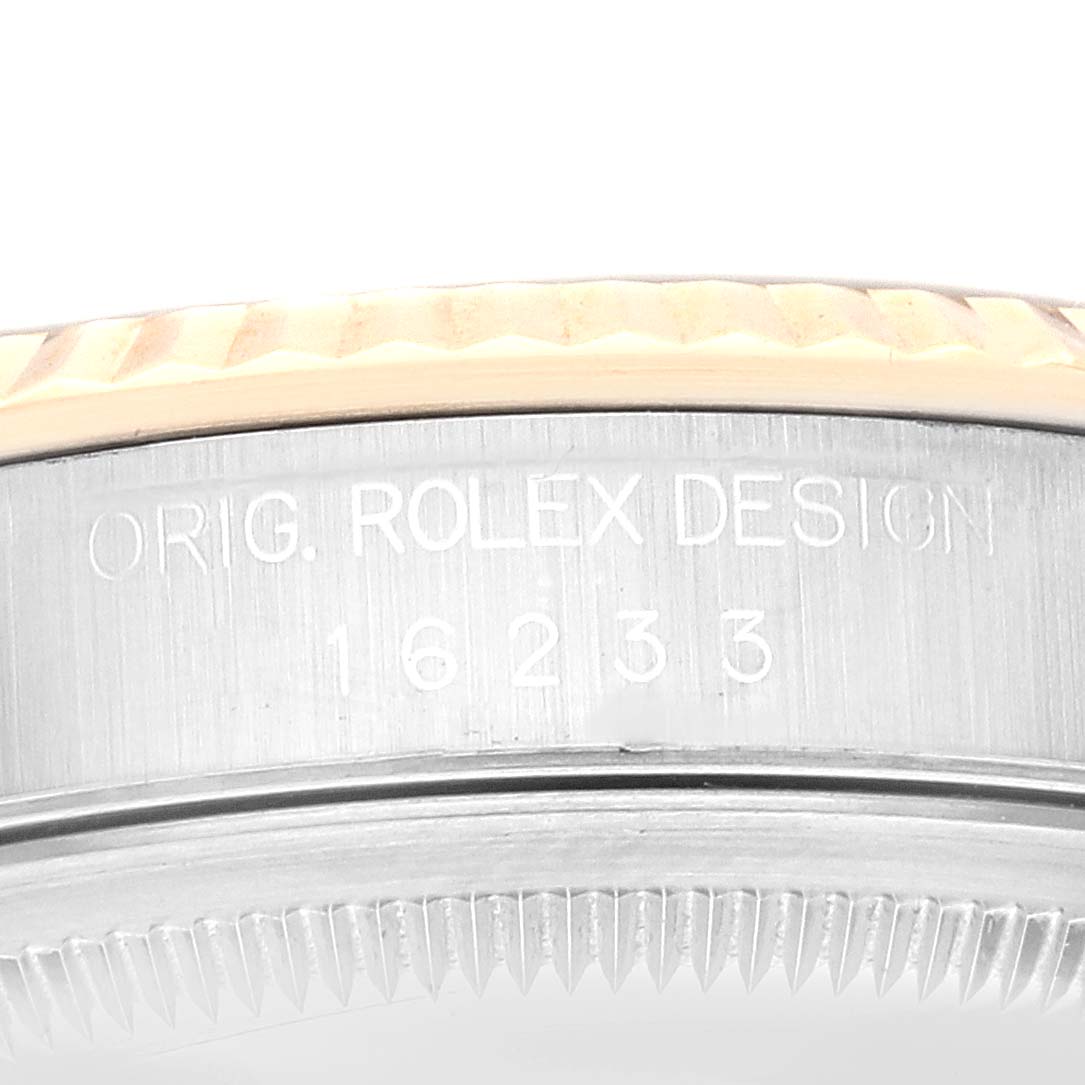 This image shows a close-up of the side of a Rolex Datejust 16233 Men's Steel and Gold (two tone) Black Dial 16233 Men's Steel and Gold (two tone) Black Dial model, focusing on the bezel and engraved serial number.