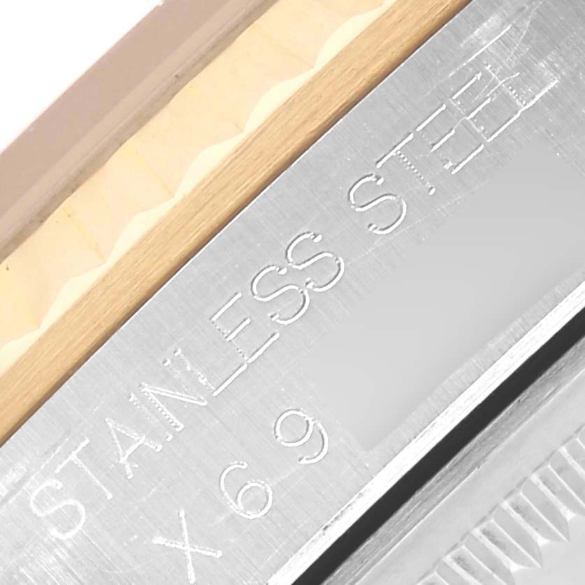 The image shows a close-up angle of the Rolex Datejust 16233 Men's Steel and Gold (two tone) Black Dial 16233 Men's Steel and Gold (two tone) Black Dial case edge, highlighting the stainless steel material and engraving.