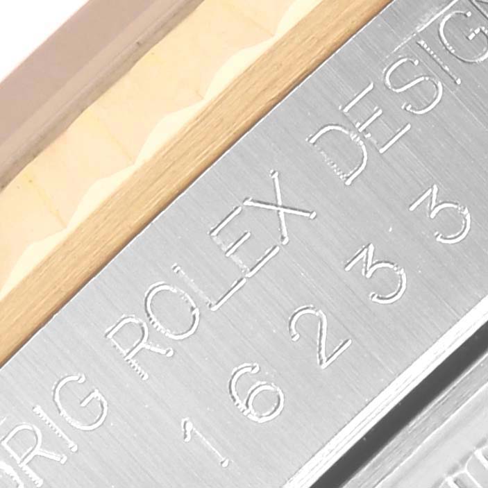 The image shows a close-up of the metal edge with engraved text on the Rolex Datejust 16233 Men's Steel and Gold (two tone) Black Dial 16233 Men's Steel and Gold (two tone) Black Dial watch, focusing on the case side.