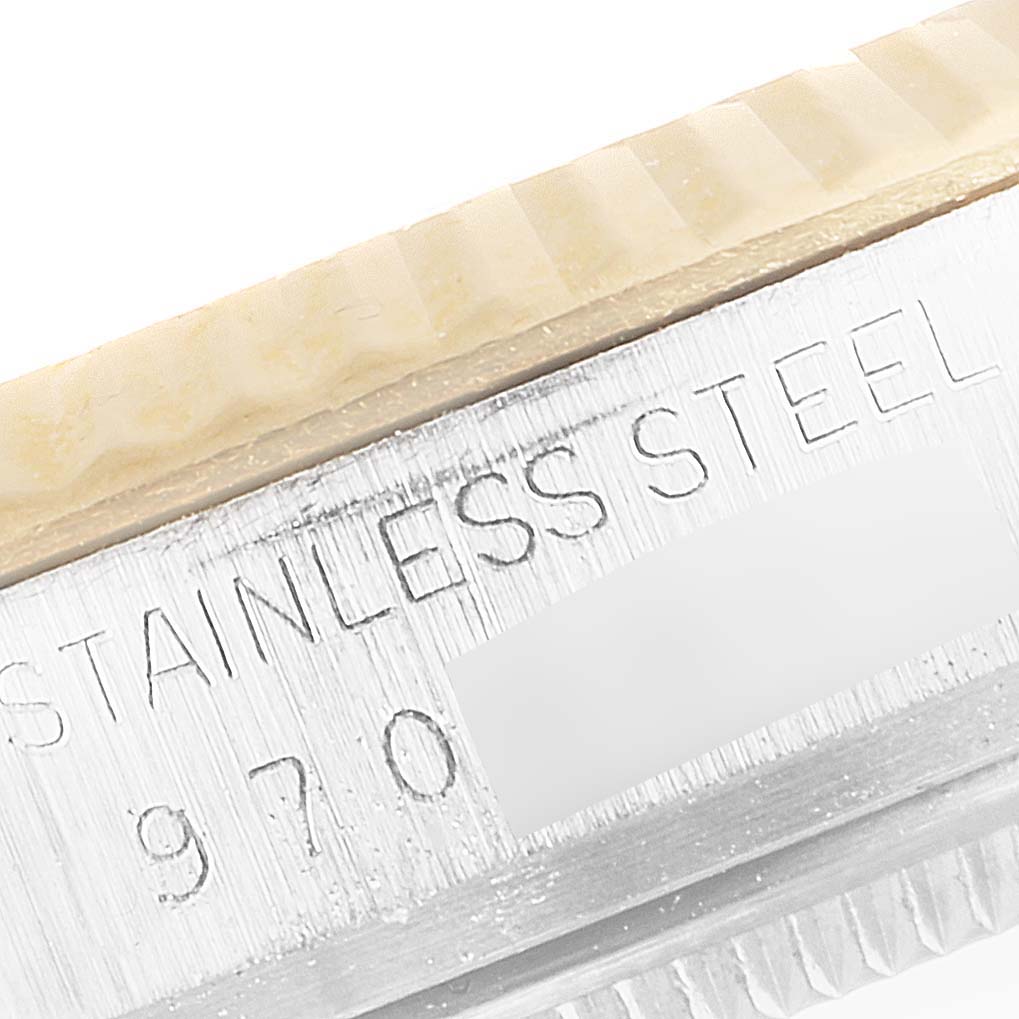 This close-up image shows the bezel and part of the case of a Rolex Datejust 16013 Men's Steel and Gold (two tone) Champagne Dial 16013 Men's Steel and Gold (two tone) Champagne Dial watch, with "STAINLESS STEEL" engraving visible.