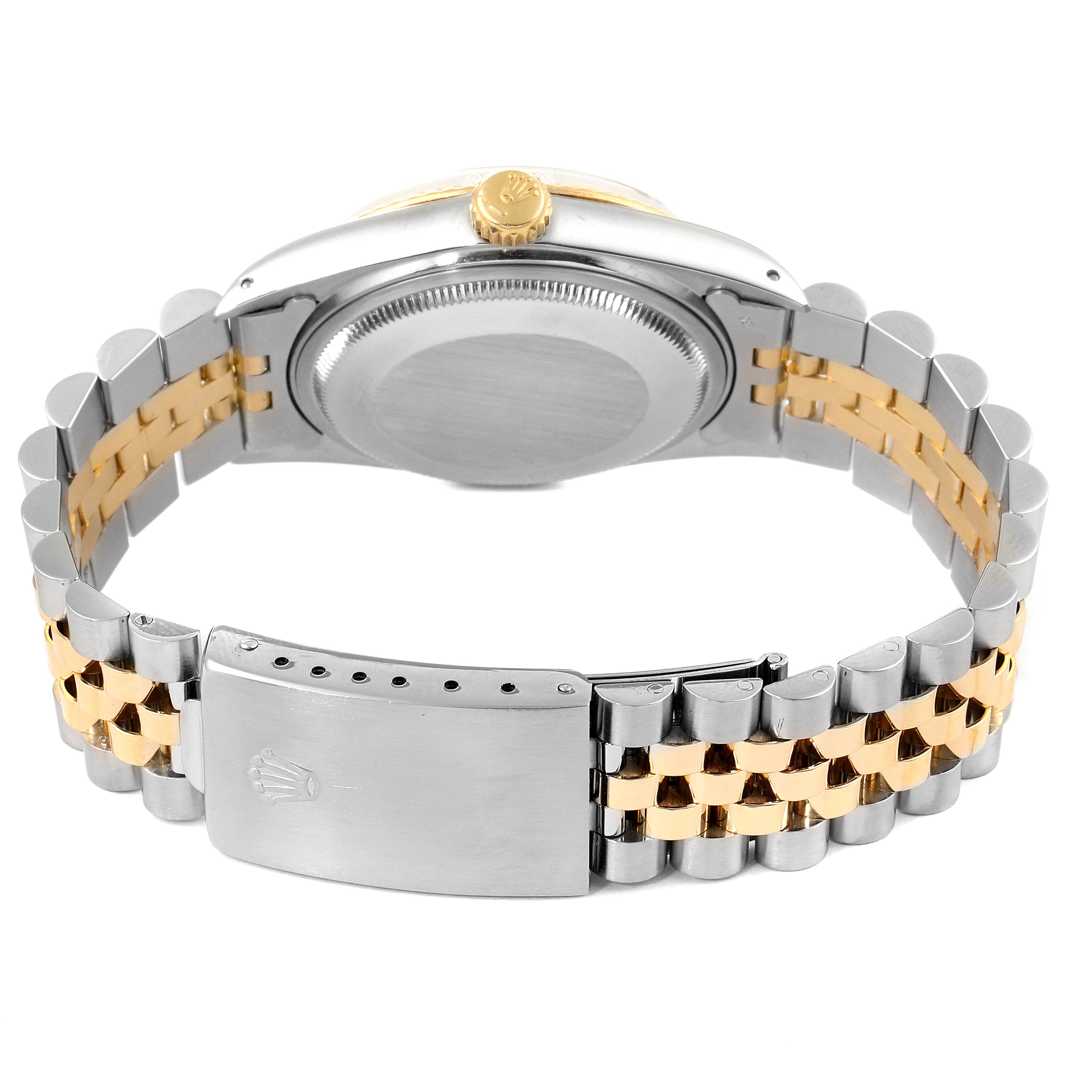 The Rolex Datejust 16013 Men's Steel and Gold (two tone) Champagne Dial 16013 Men's Steel and Gold (two tone) Champagne Dial watch is shown from the back, highlighting its case, crown, and two-tone bracelet with clasp.