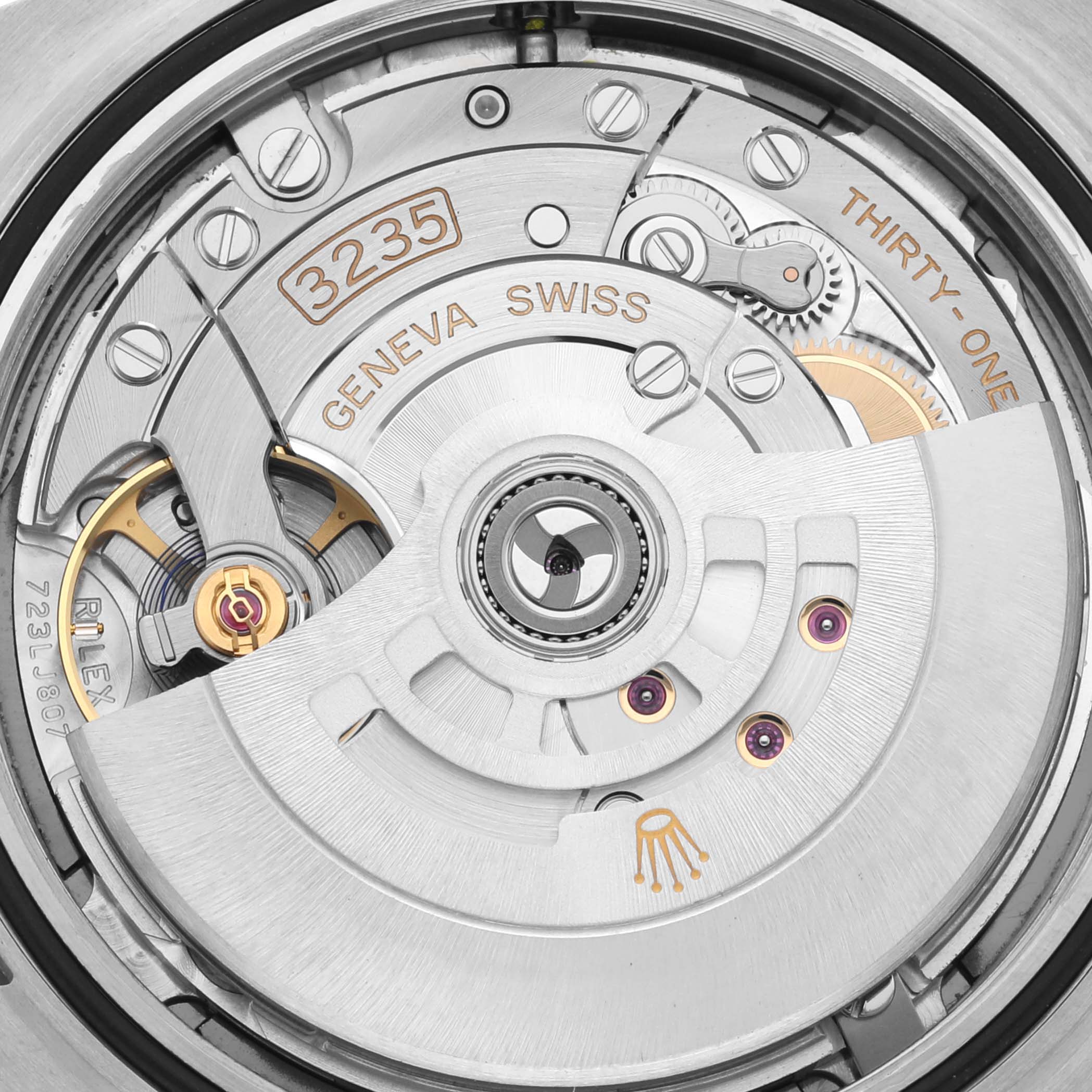 The image shows the intricate movement of the Rolex Datejust 41 126334 Men's Stainless Steel Grey Dial 126334 Men's Stainless Steel Grey Dial, focusing on the rotor and internal mechanisms from a close-up angle.