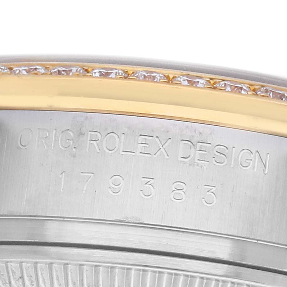 The image shows the side view of a Rolex Datejust 179383 Women's Steel and Gold (two tone) Champagne Dial watch with its engraved case and a diamond-set bezel.