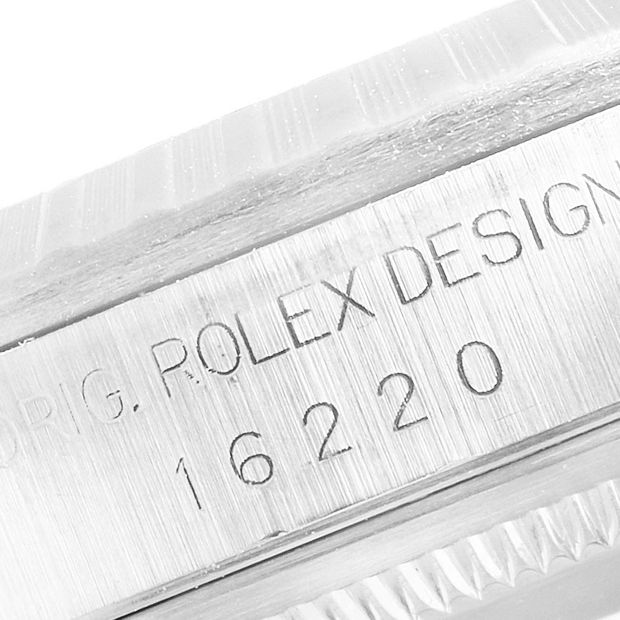 The image shows the side angle of a Rolex Datejust 16220 Men
s Stainless Steel Blue Dial 16220 Men
s Stainless Steel Blue Dial, featuring the engraved model number and "Rolex Design."