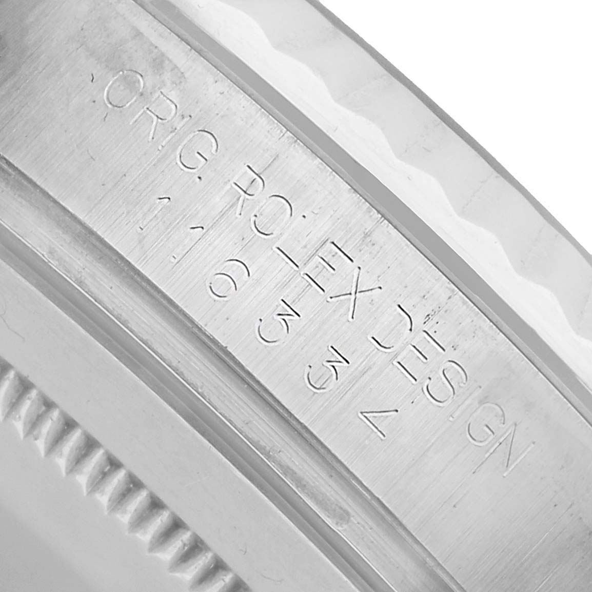 The image shows a close-up angle of the inner bezel of a Rolex Datejust 41 116334 Men's Stainless Steel Blue Dial, displaying engraved text details.