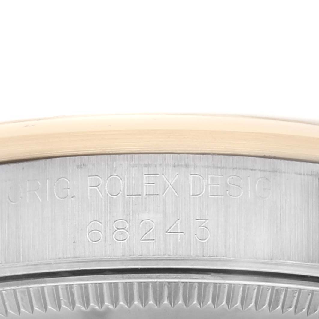 The image shows the serial number engraving on the side of a Rolex Mid-Size 68243 Women's Steel and Gold (two tone) Champagne Dial 68243 Women's Steel and Gold (two tone) Champagne Dial model watch case.