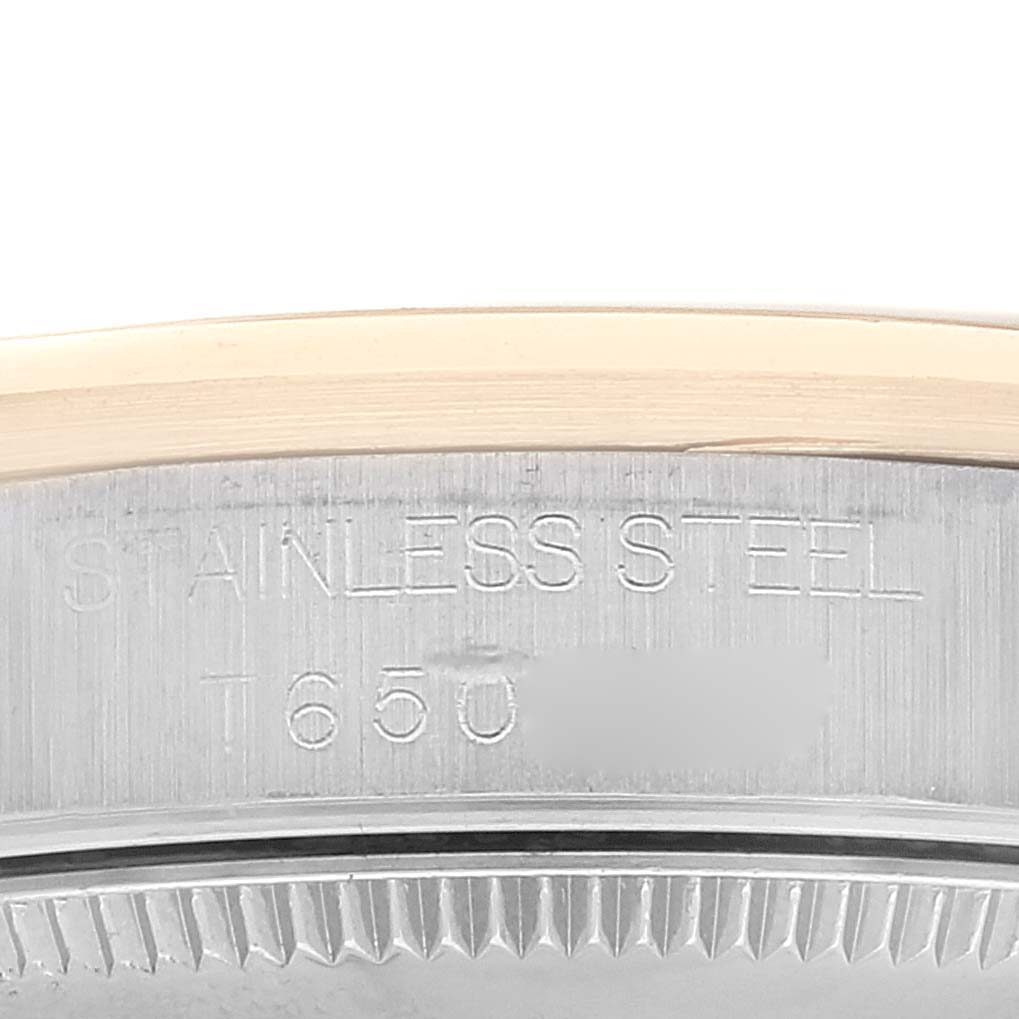 The image shows the side of the stainless steel case with engraved text of a Rolex Mid-Size 68243 Women's Steel and Gold (two tone) Champagne Dial 68243 Women's Steel and Gold (two tone) Champagne Dial model watch.