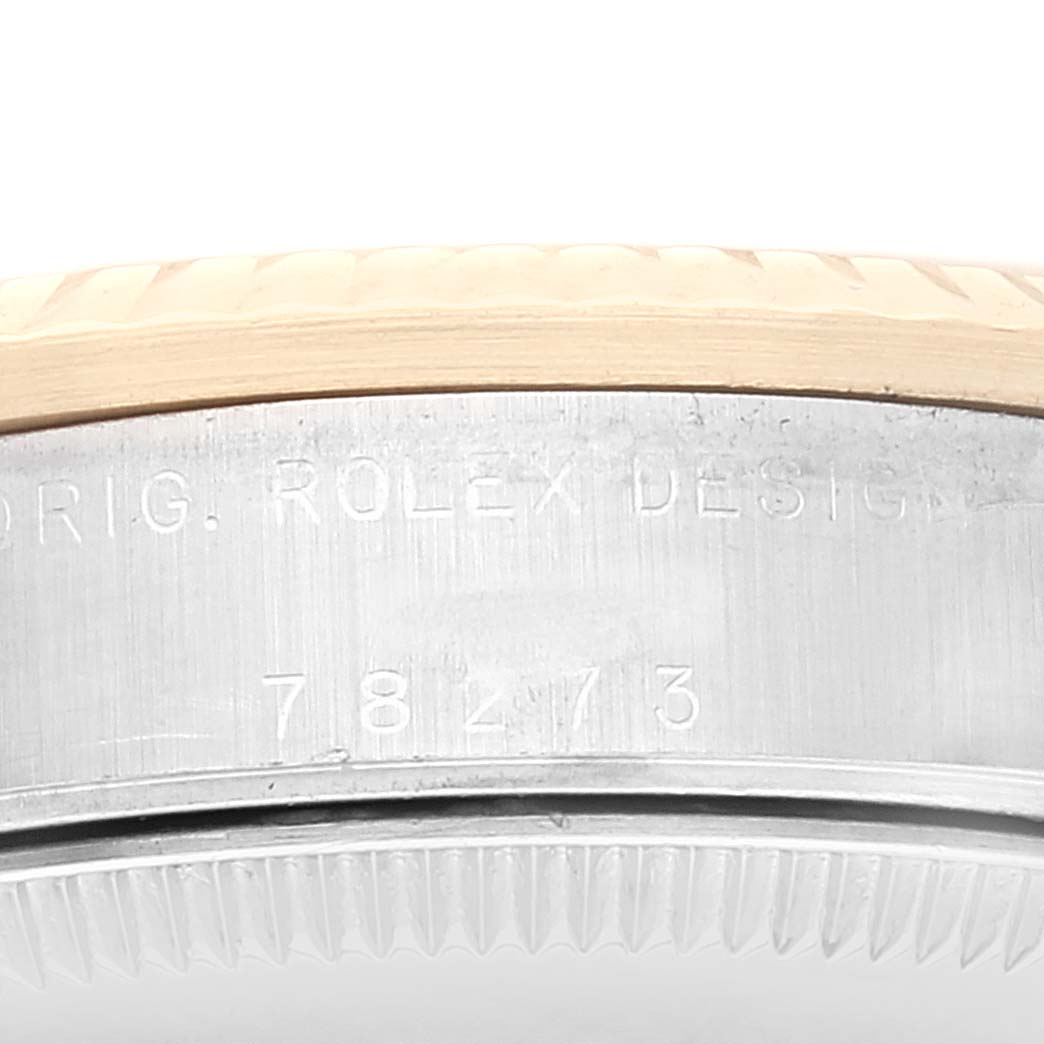 This image shows the side of a Rolex Mid-Size 78273 Women
s Steel and Gold (two tone) White Dial 78273 Women
s Steel and Gold (two tone) White Dial watch, highlighting the engraved model number and bezel design.
