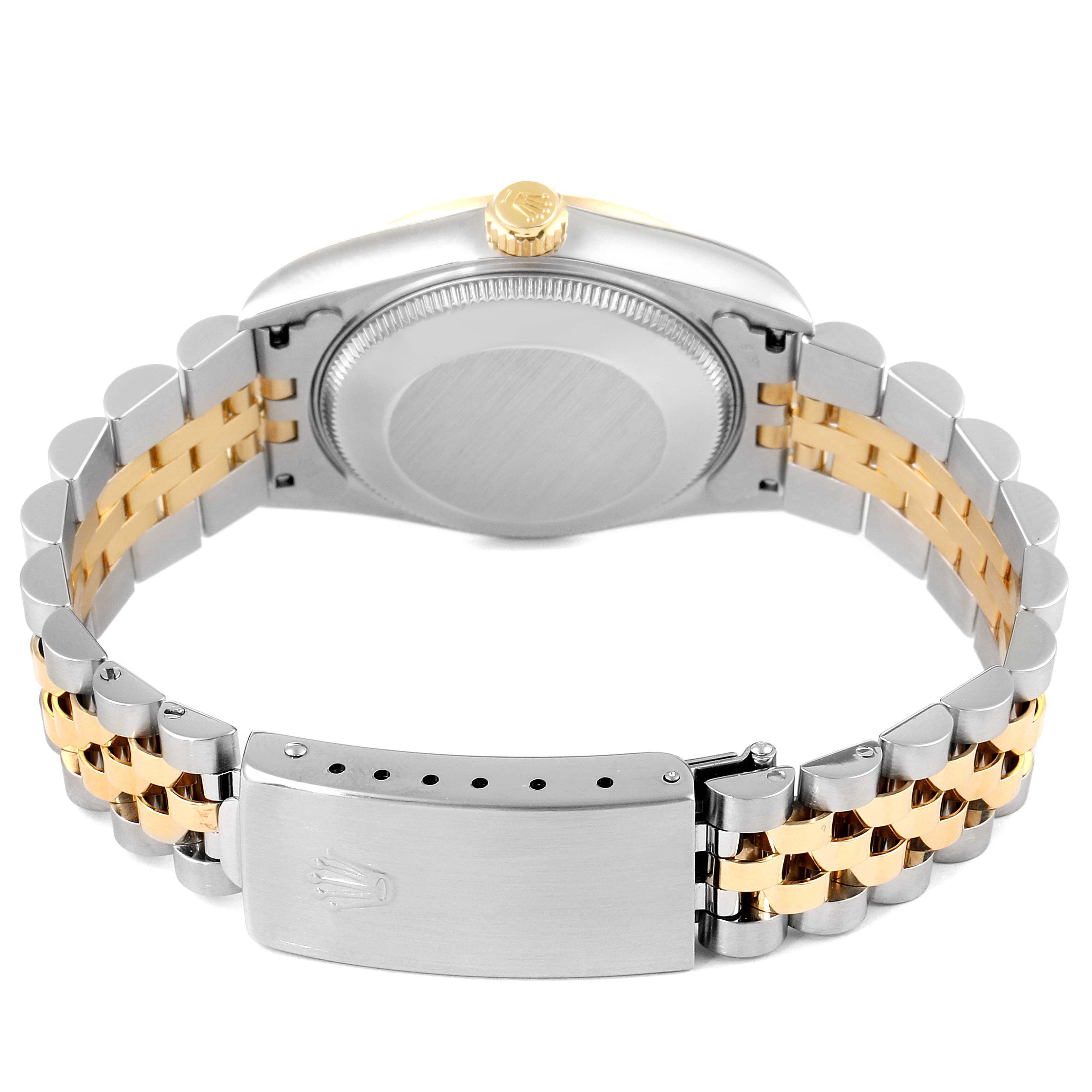 This image shows the back case and clasp of a Rolex Mid-Size 68273 Women
s Steel and Gold (two tone) Black Dial 68273 Women
s Steel and Gold (two tone) Black Dial watch, highlighting its two-tone band.