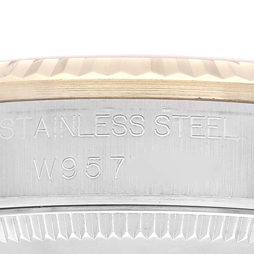 The image shows a close-up view of the stainless steel bezel and part of the casing of a Mid-Size Rolex watch.