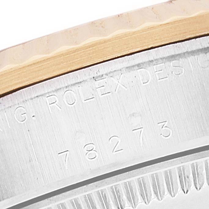 This close-up image shows part of the case and bezel of a Rolex Mid-Size 78273 Women
s Steel and Gold (two tone) Champagne Dial 78273 Women
s Steel and Gold (two tone) Champagne Dial model, including its engraved serial number.