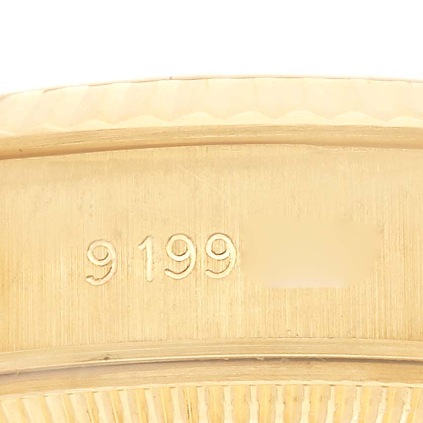 The image shows the edge and serial number engraving on a Rolex President 69178 Women's Yellow Gold Champagne Dial 69178 Women's Yellow Gold Champagne Dial watch bezel.