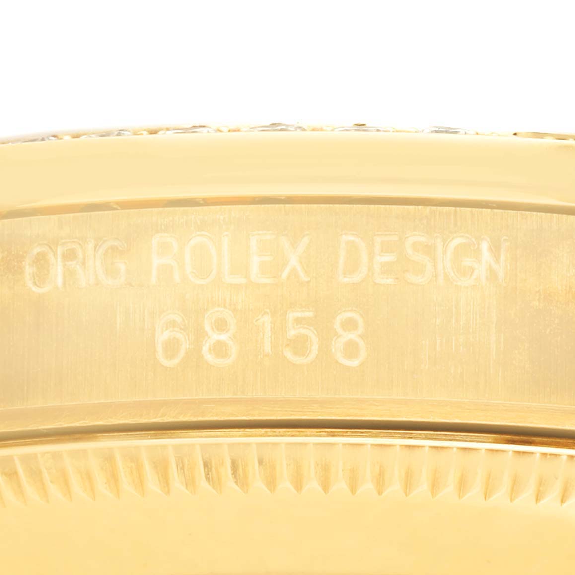 The image shows an angled view of the case edge with engraved text on the Rolex President 68158 Women's Yellow Gold Champagne Dial 68158 Women's Yellow Gold Champagne Dial model.