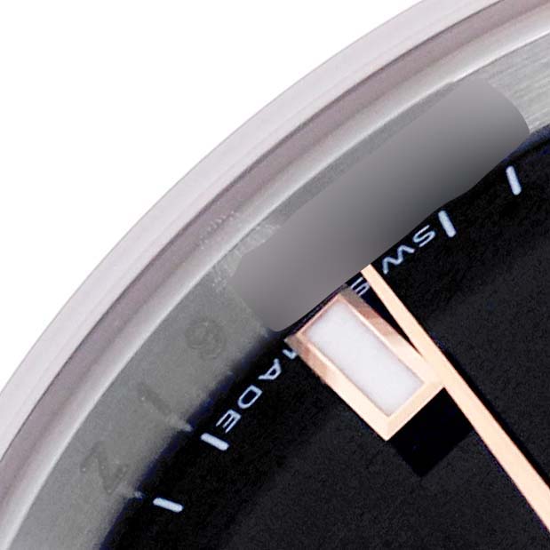 This image shows a close-up of the Rolex Datejust 179161 Women
s Steel and Gold (two tone) Black Dial 179161 Women
s Steel and Gold (two tone) Black Dial dial edge, highlighting part of the hour marker and minute hand.